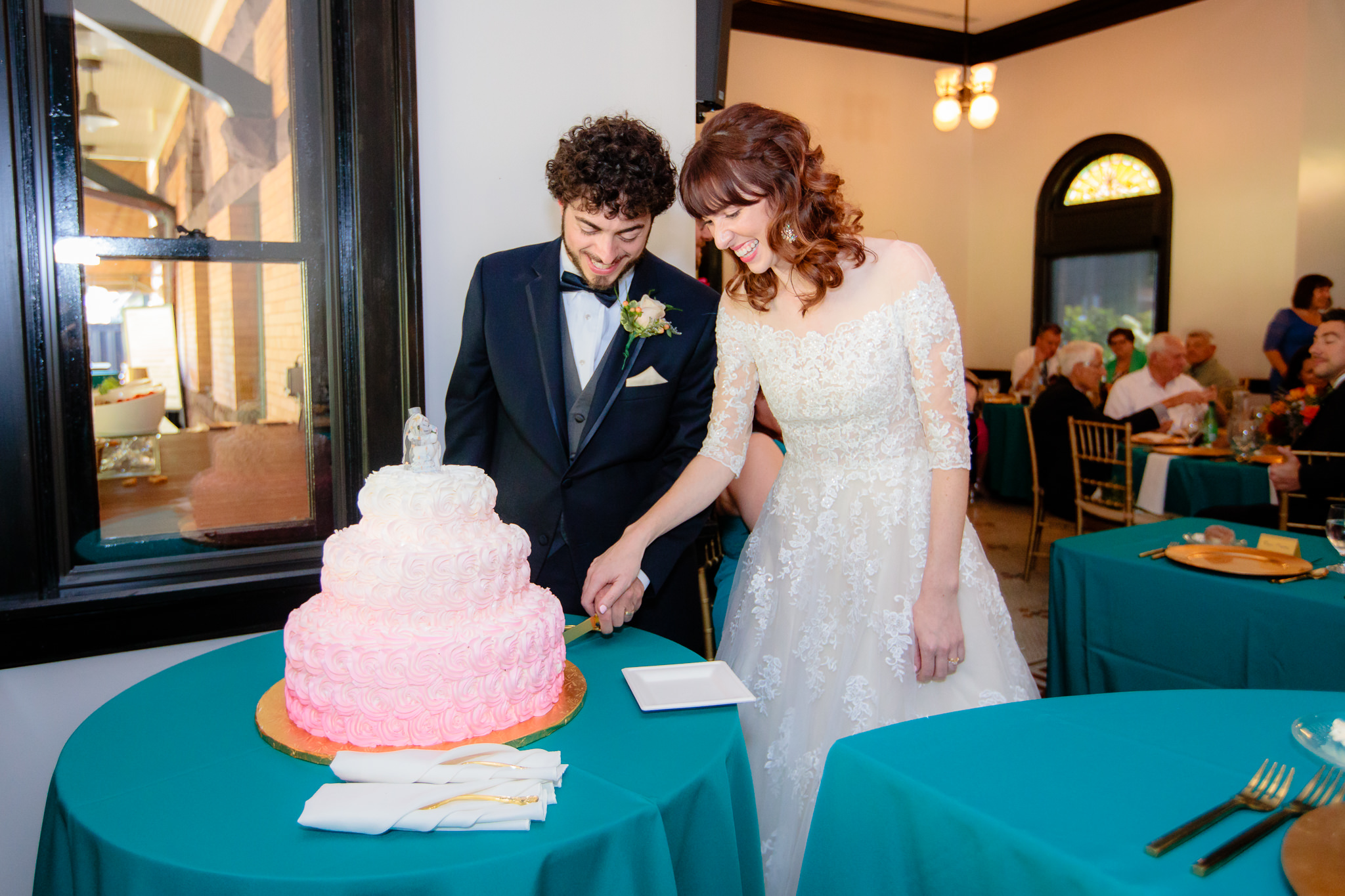 Newlyweds cut their cake by Kretchmar's bakery at a Beaver Station wedding