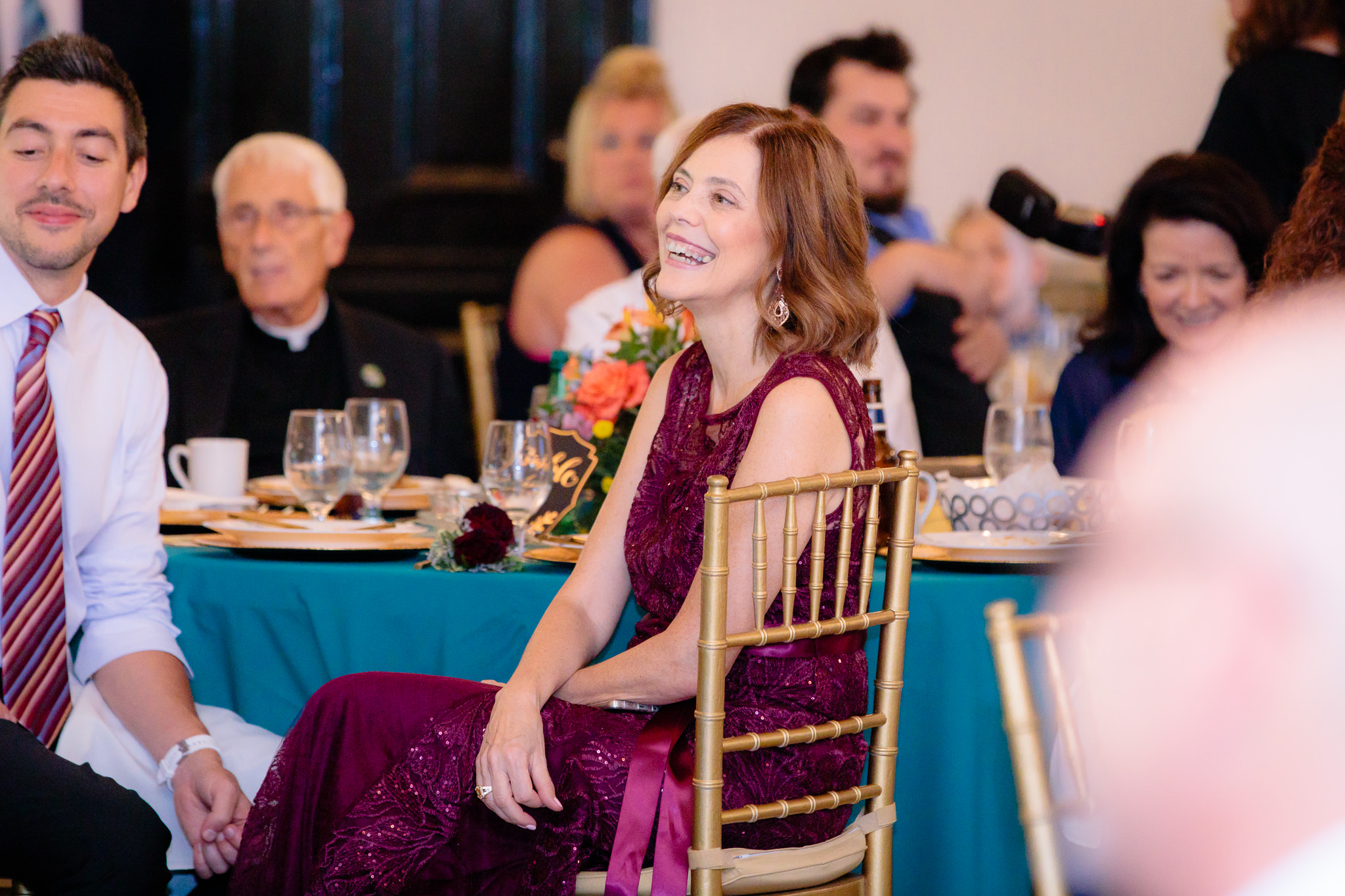 Mother of the bride laughs during speeches at a Beaver Station wedding reception