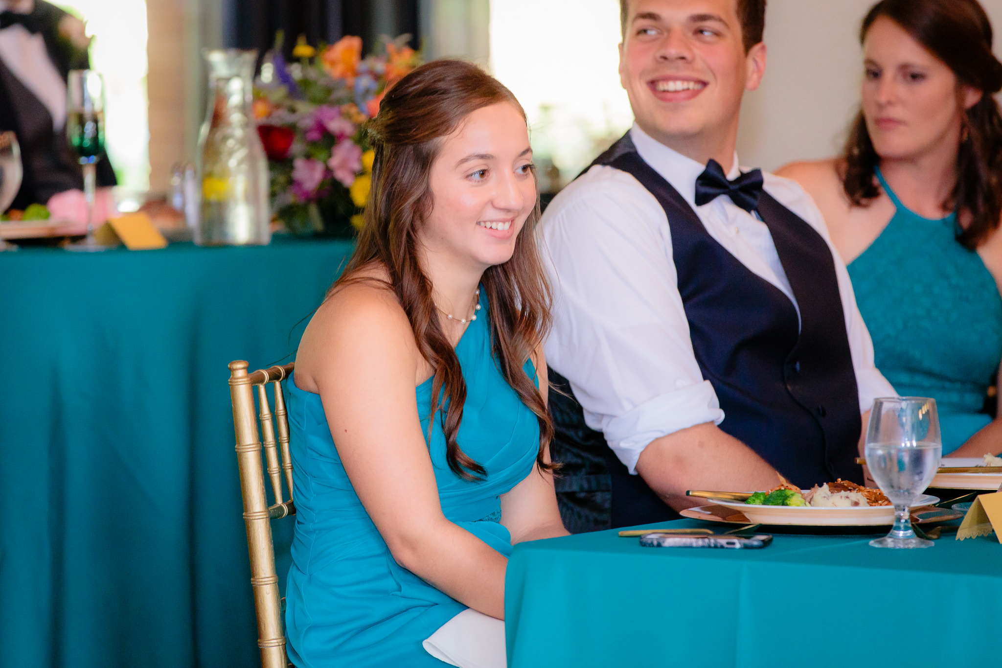 Bridesmaid smiles during speeches at a Beaver Station wedding reception