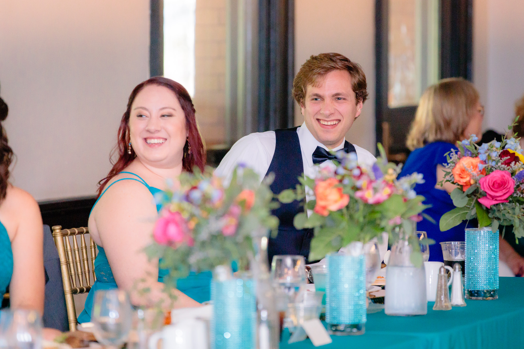 Groomsman laughs during speeches at a Beaver Station wedding