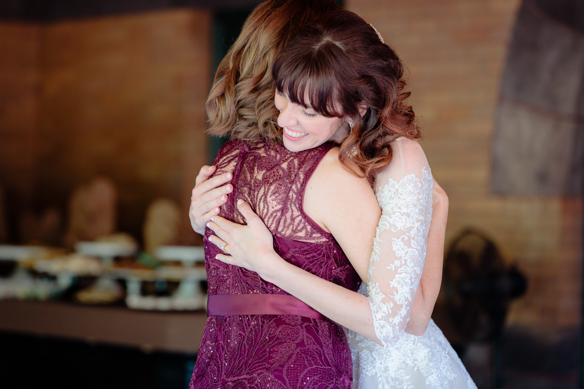 Bride hugs her mother during parent dances at a Beaver Station wedding