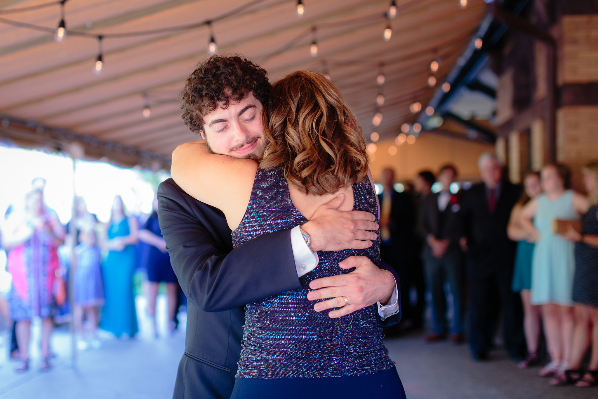 Groom hugs his mother during parent dances at a Beaver Station wedding