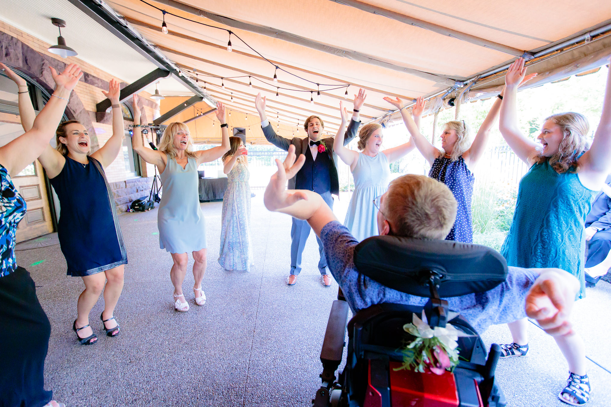 Guests dance to the YMCA at a Beaver Station wedding
