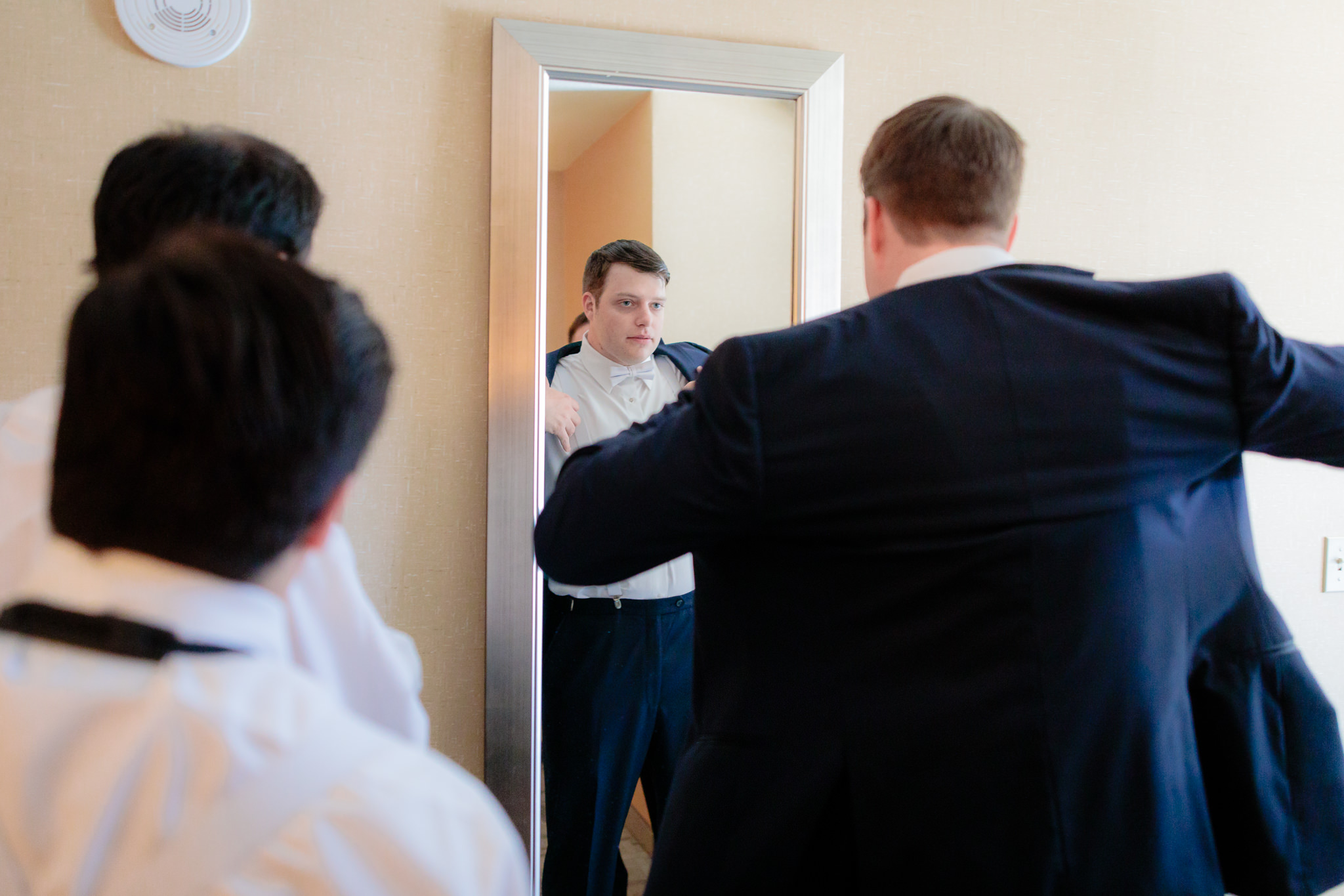 Groom puts on his blue tux jacket from Men's Wearhouse at Cambria Hotel in downtown Pittsburgh