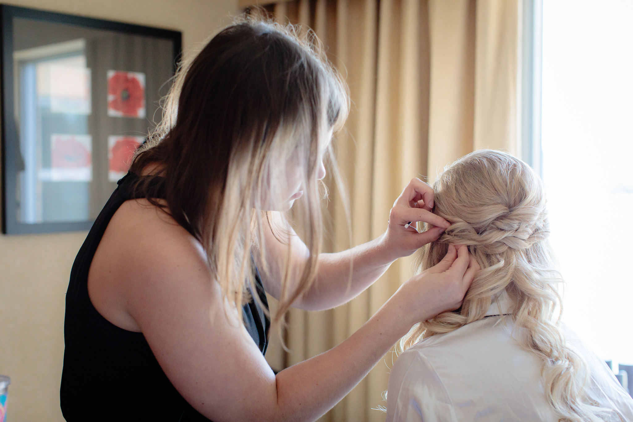 Stephanie Maust of Eye Do Makeup & Hair puts finishing touches on bride's hair