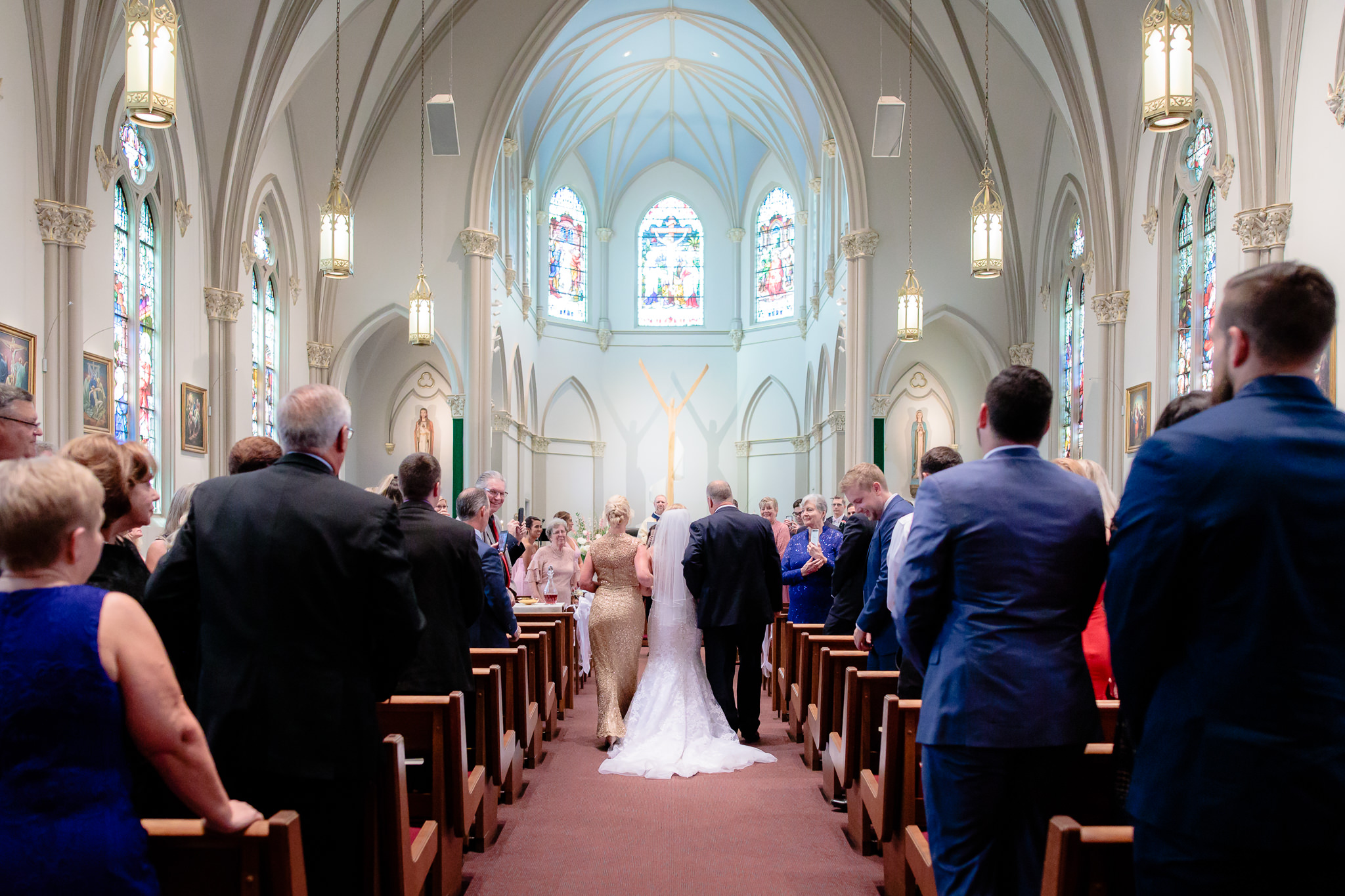 Bride's parents walk her down the aisle at her Duquesne University wedding ceremony