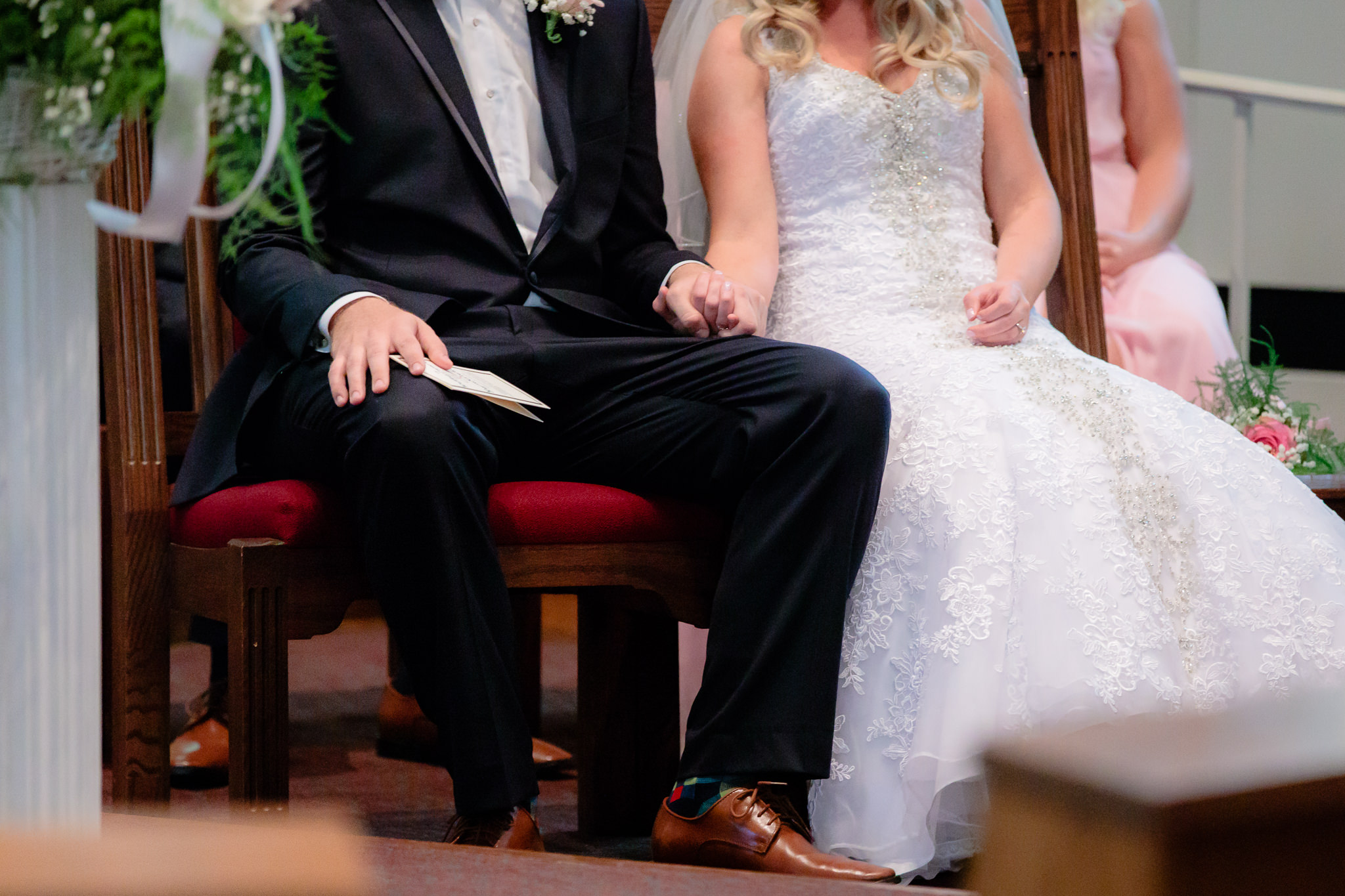 Bride & groom hold hands during their ceremony at Duquesne University's Chapel of the Holy Spirit