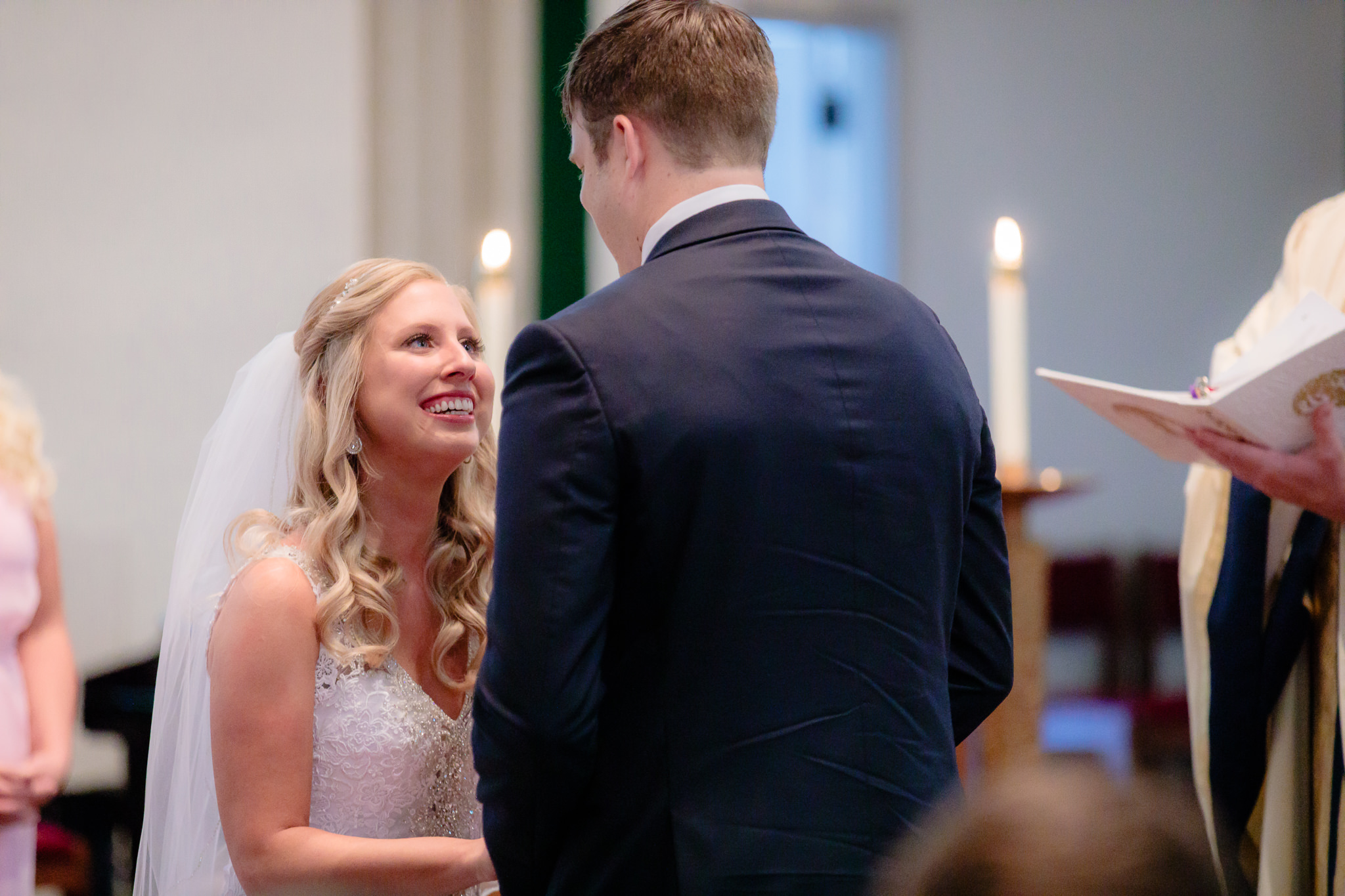 Bride smiles as groom says his vows at Duquesne University Chapel of the Holy Spirit