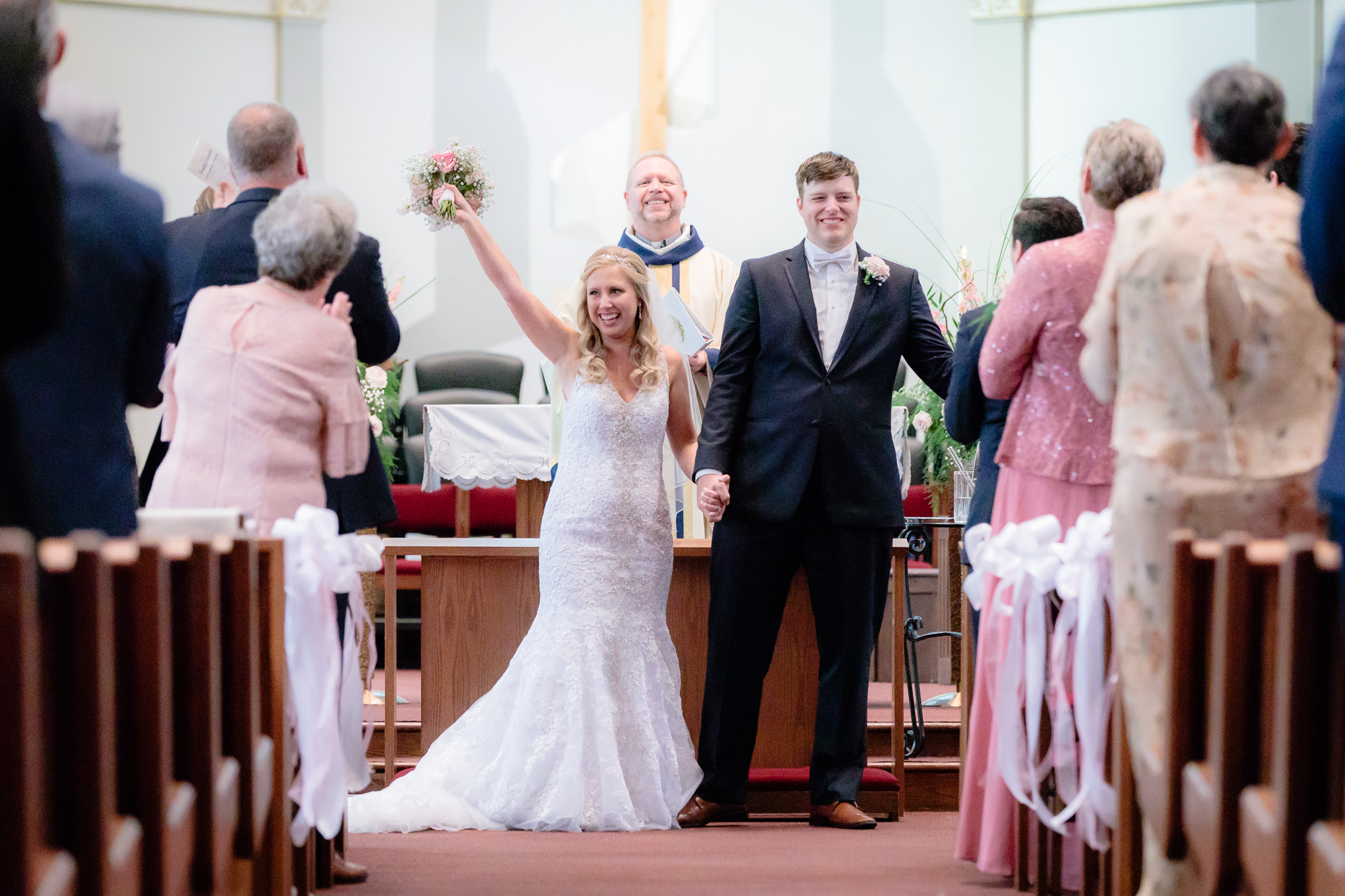 Newlyweds cheer after being married in the Duquesne University Chapel of the Holy Spirit