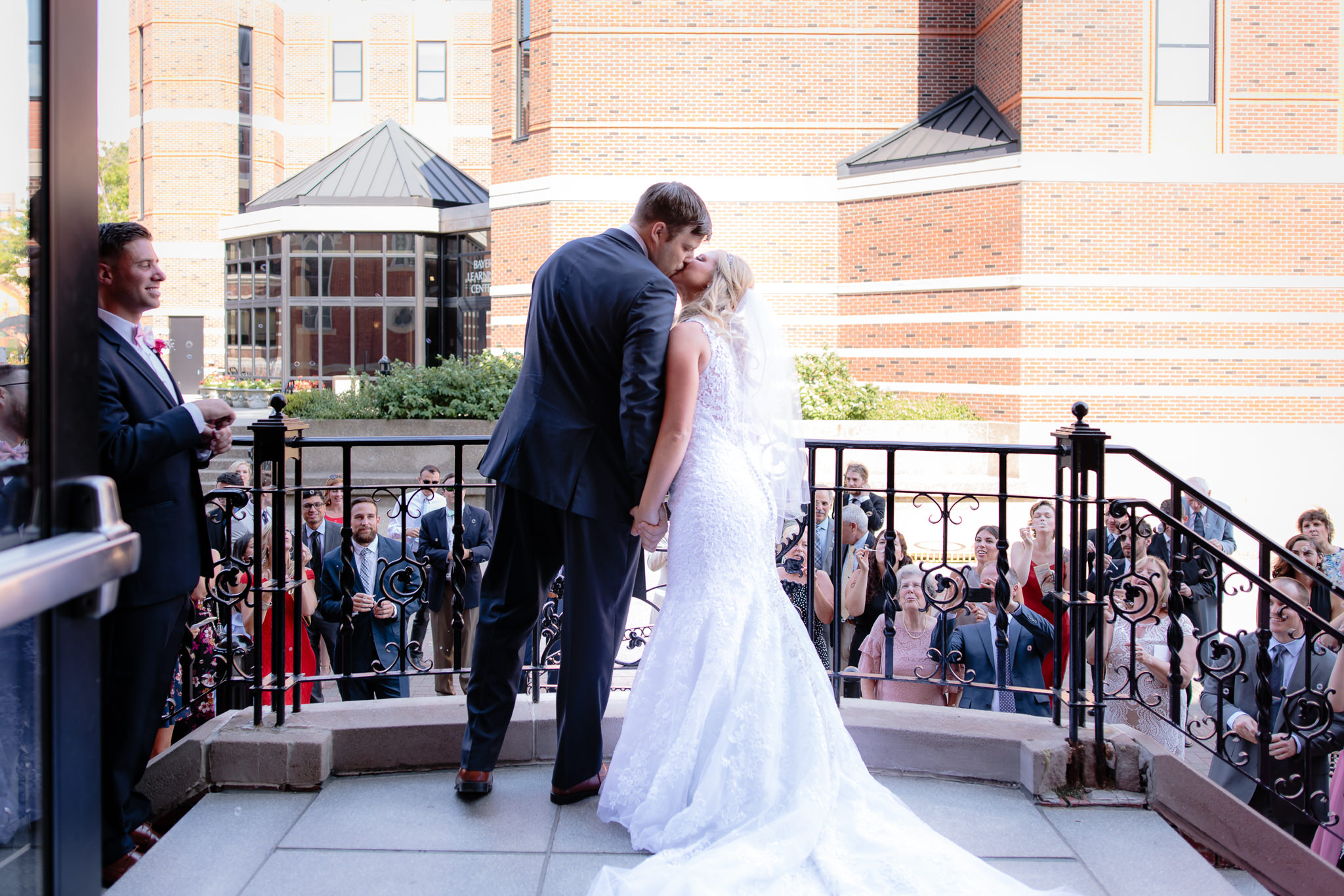 Newlyweds kiss during bubble exit at Duquesne University