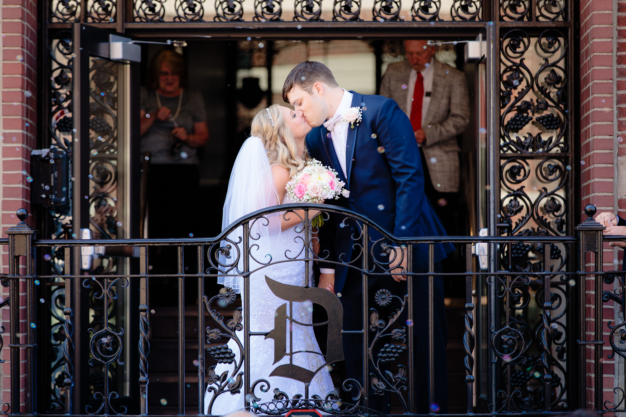 Newlyweds kiss during bubble exit at Duquesne University's Chapel of the Holy Spirit