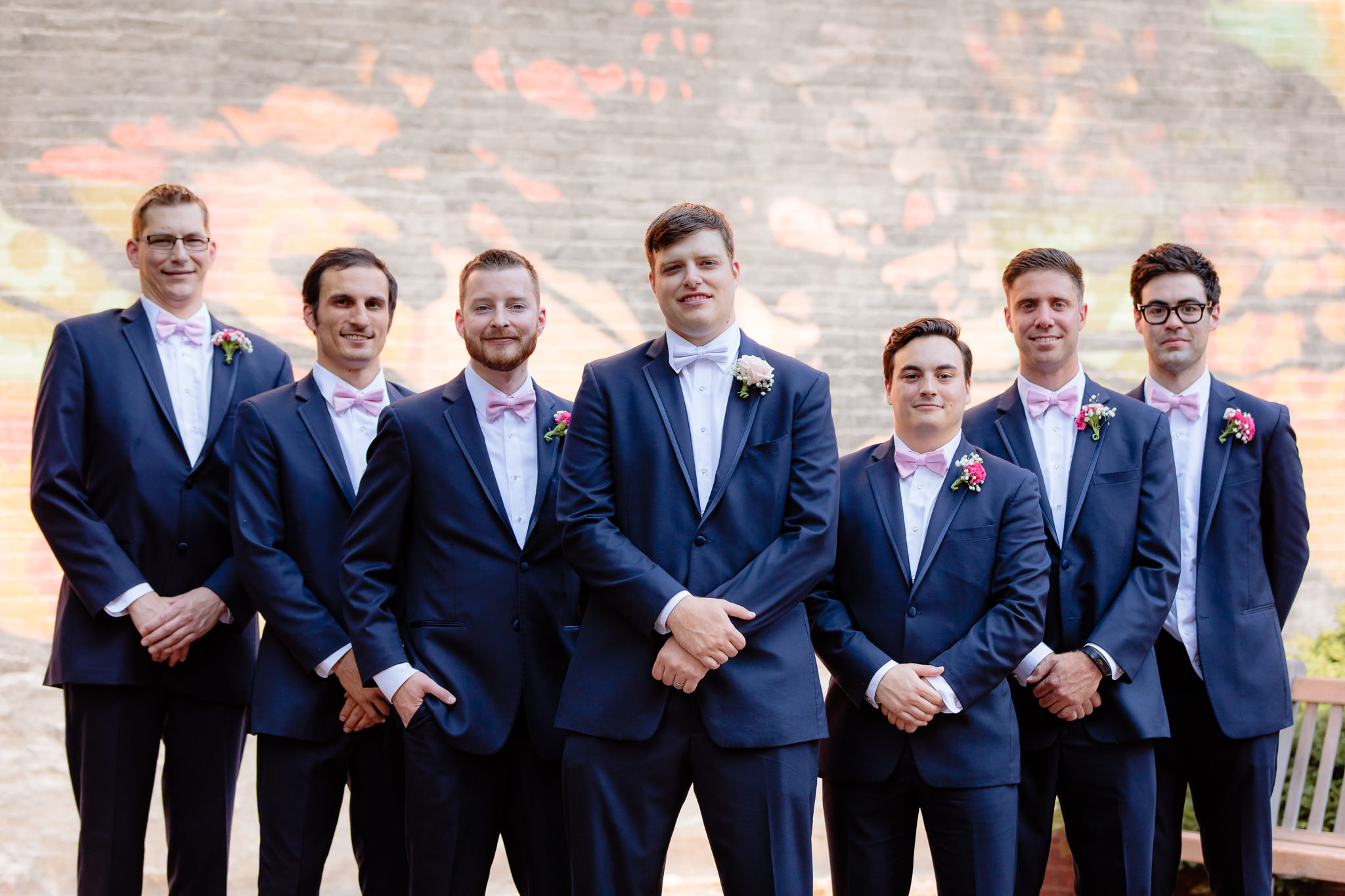 Groomsmen wear blue tuxedos and pink bowties at Duquesne University