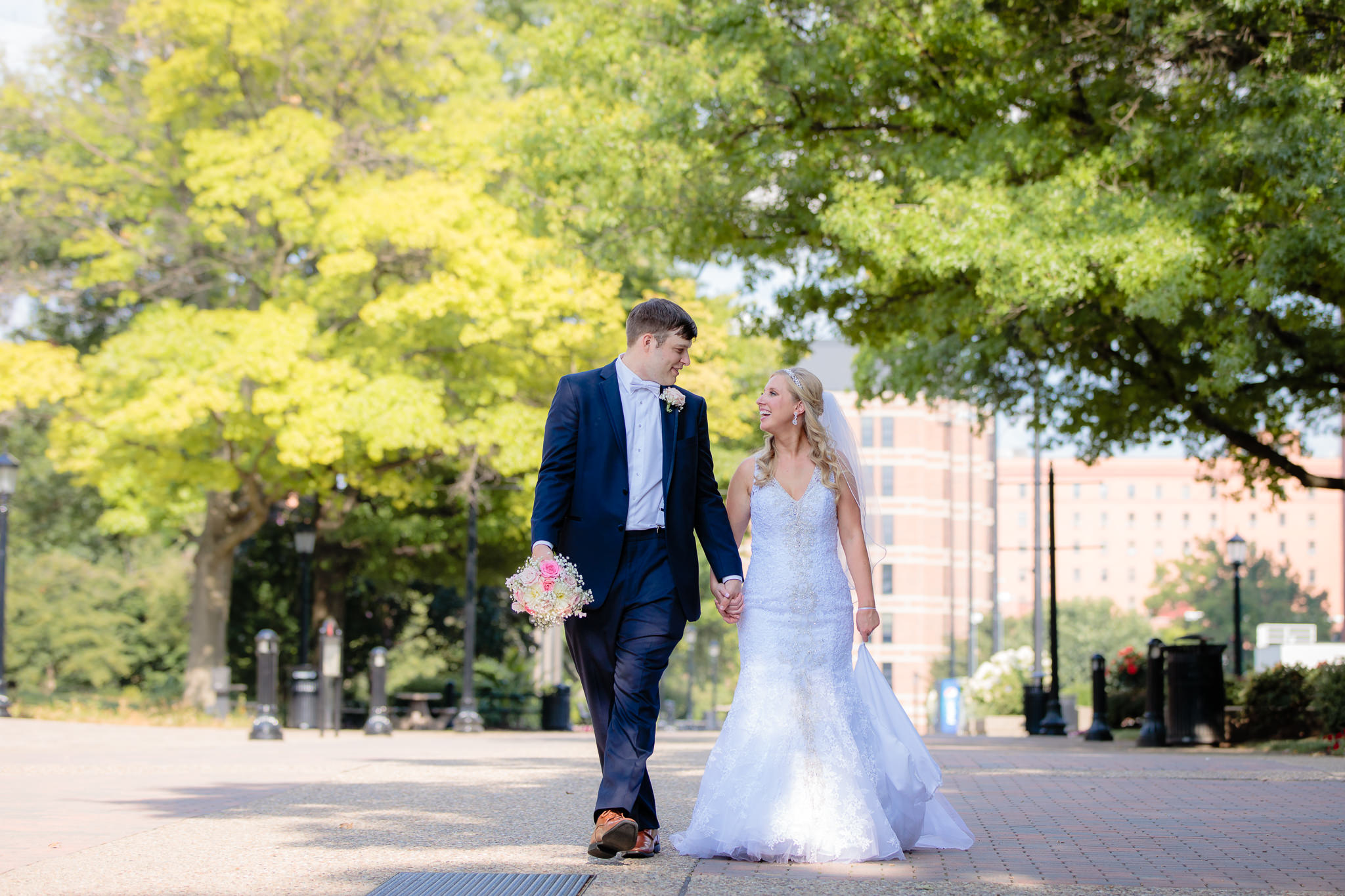 Newlyweds walk down Academic Walk at Duquesne University