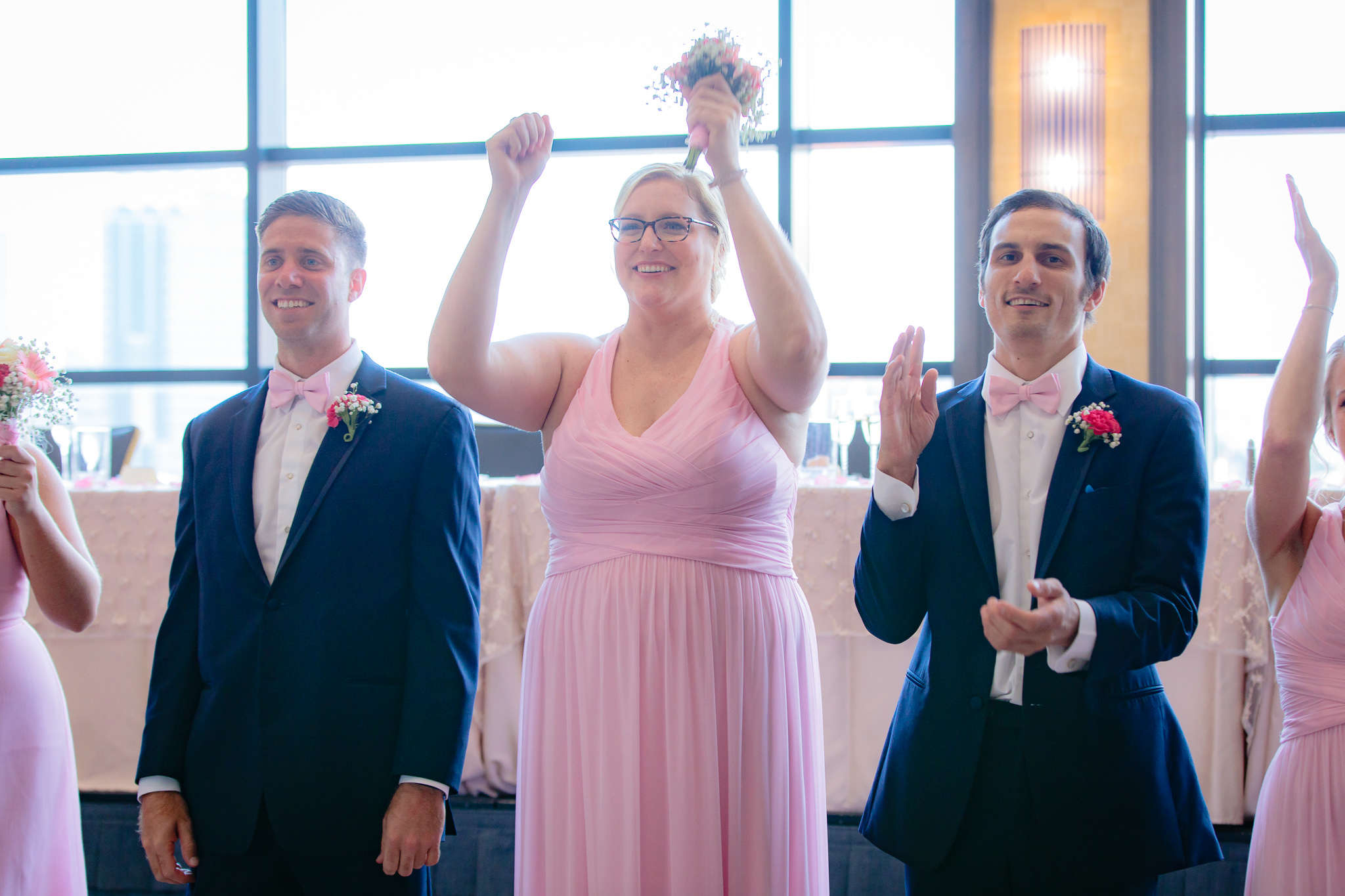 Sister of the groom cheers as newlyweds enter their Duquesne University wedding reception