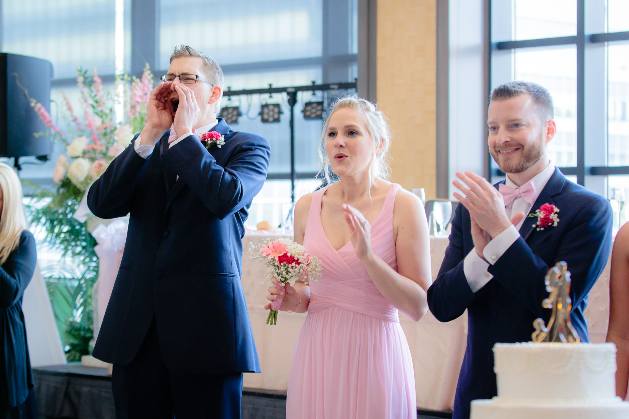 Brothers of the groom cheer as newlyweds enter their Duquesne University reception