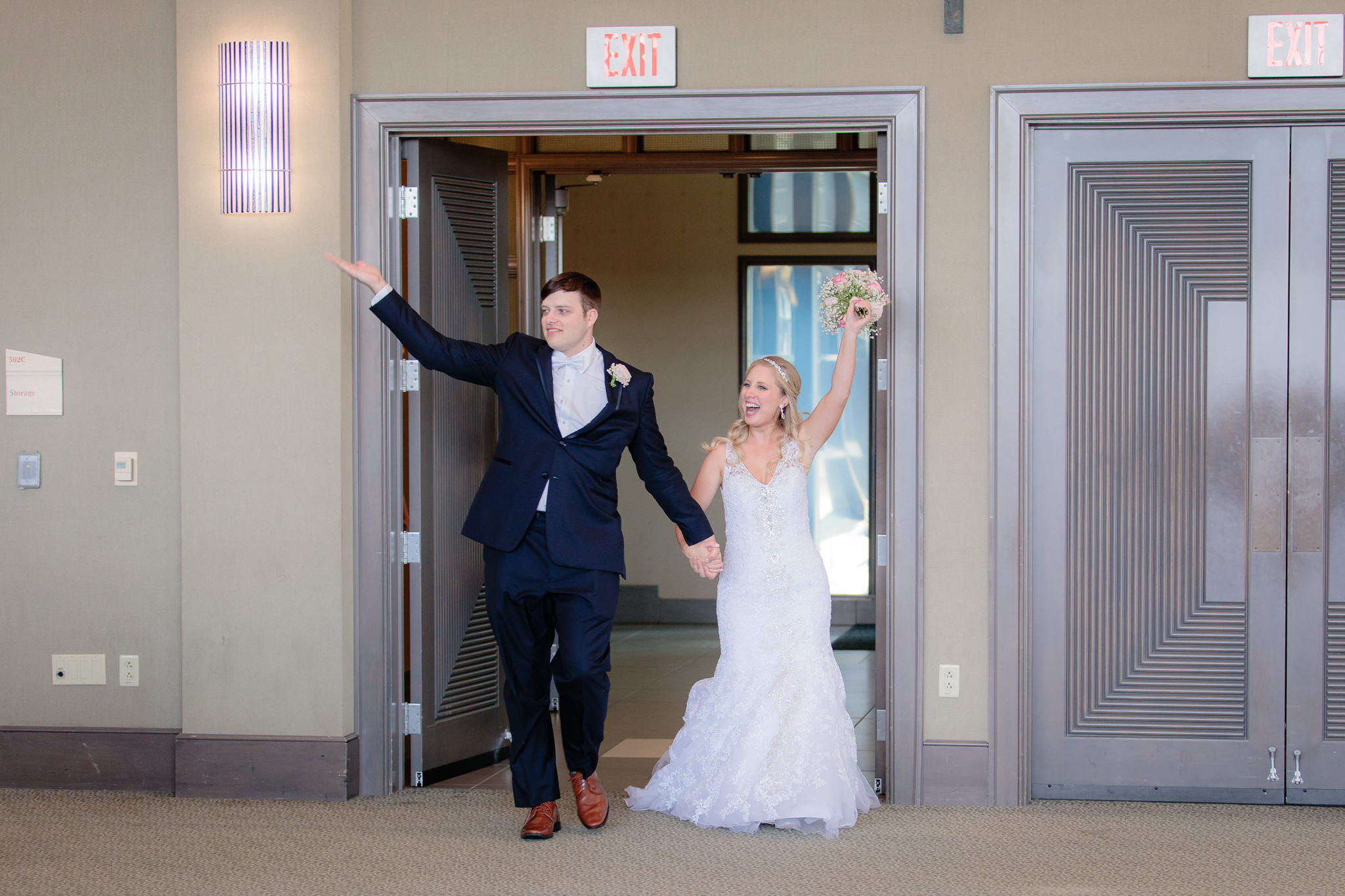 Newlyweds enter the Charles J. Dougherty ballroom for their reception at Duquesne University