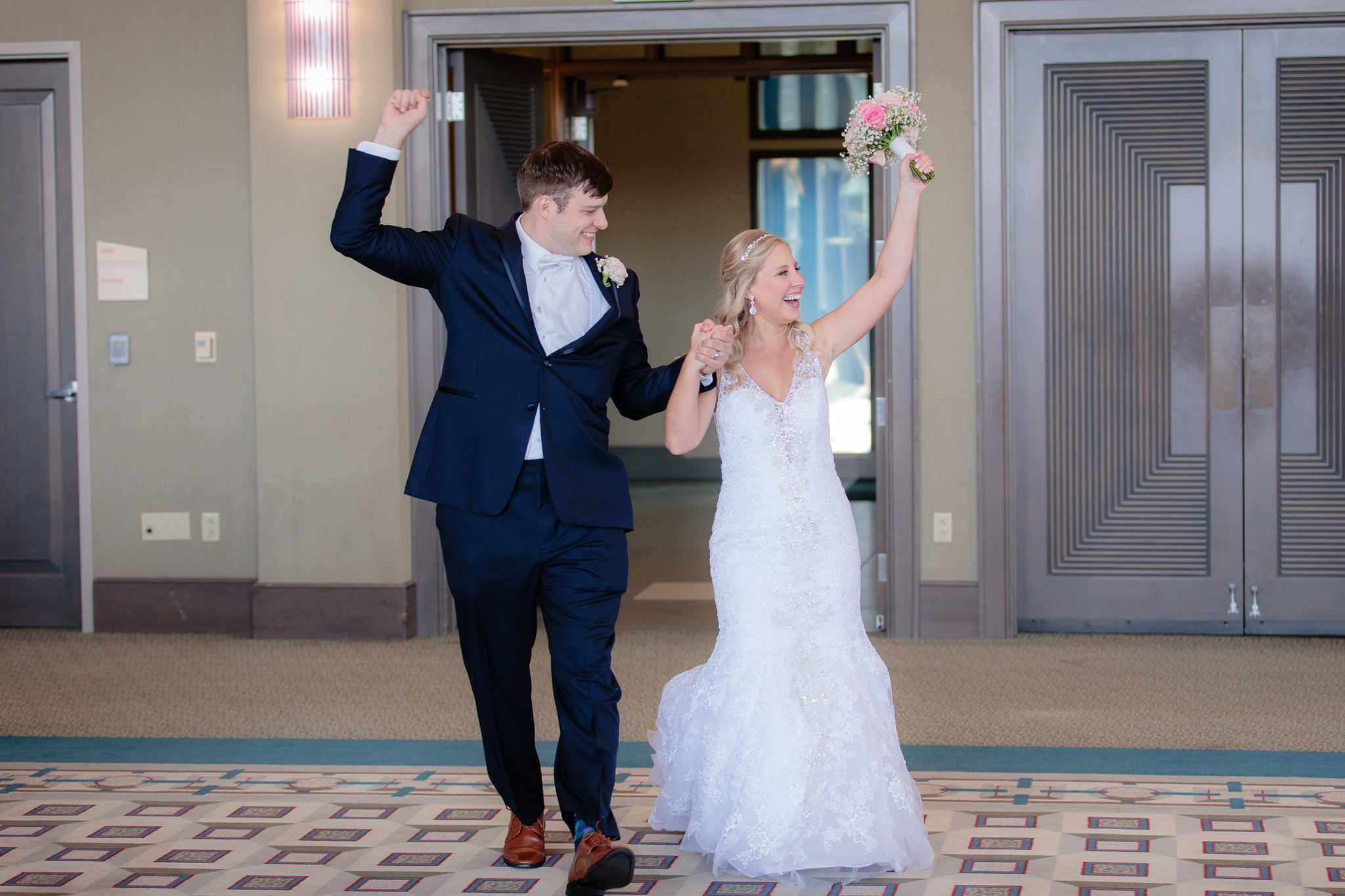 Newlyweds cheer as they enter their Duquesne University wedding reception