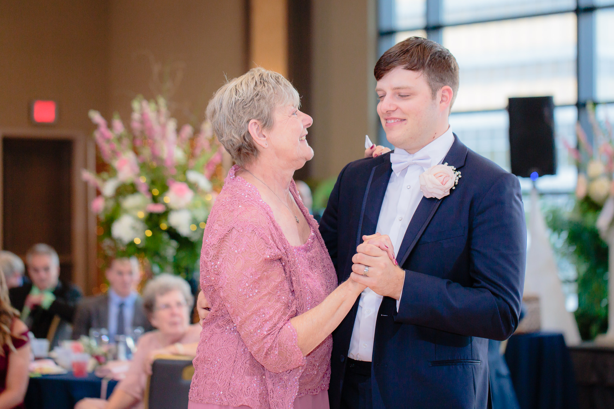 Mother of the groom dances with her son at Duquesne University
