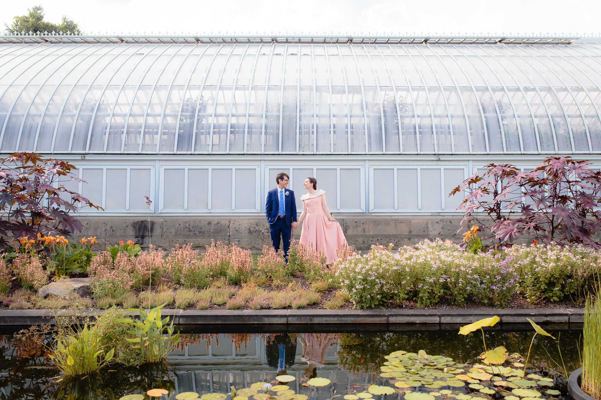 Bride & groom's reflection shows in the pond at Phipps