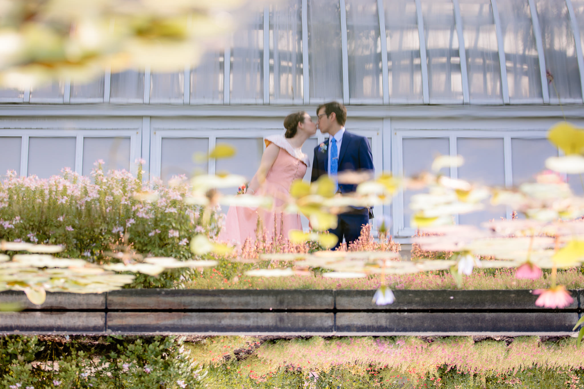 Reflection of the bride kissing her groom before their Phipps Conservatory wedding