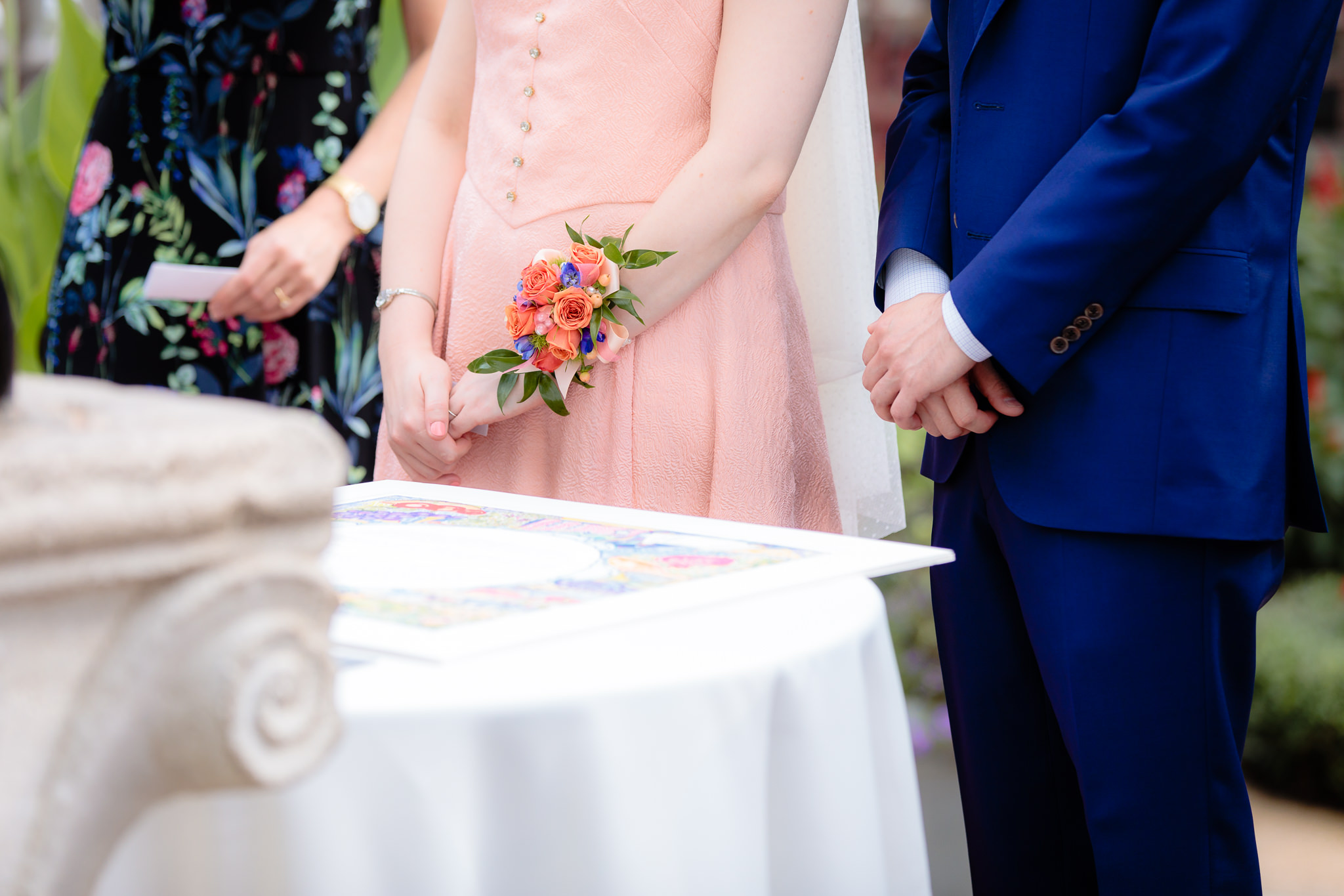Closeup of bride & groom's hands as they wait to sign their Ketubah at Phipps Conservatory