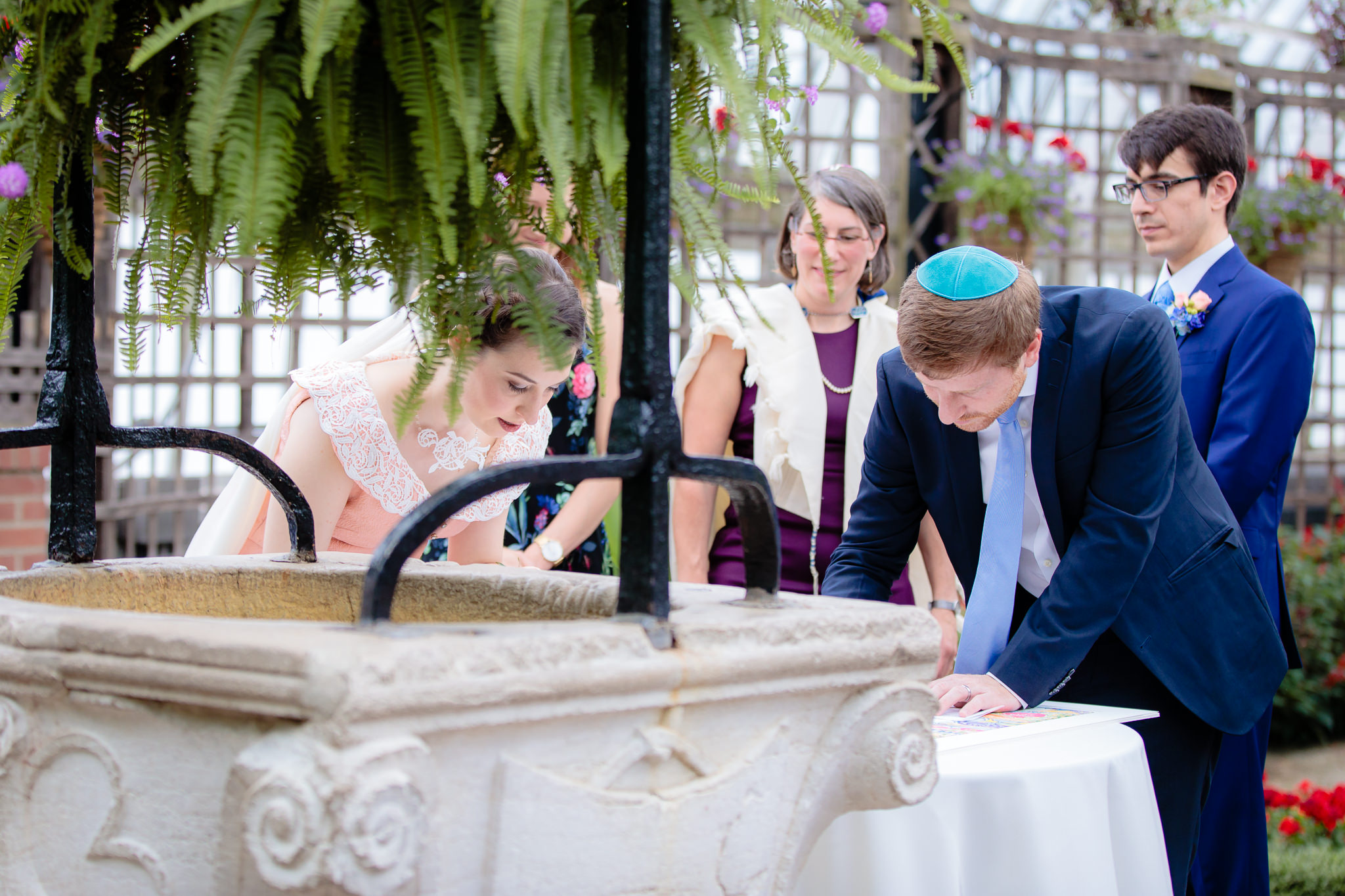 Male witness signs the Ketubah at Phipps Conservatory
