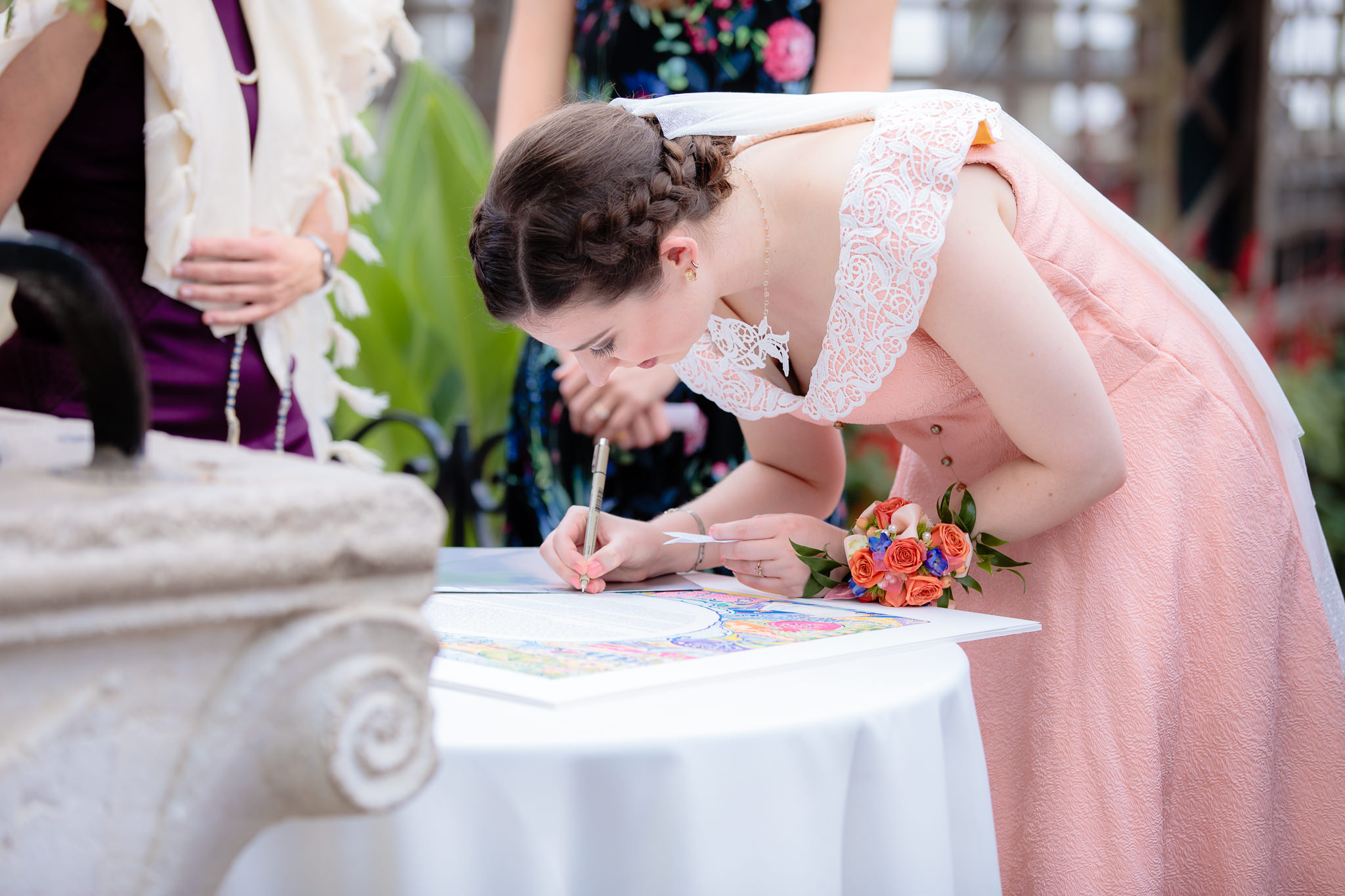Bride signs the Ketubah at Phipps Conservatory