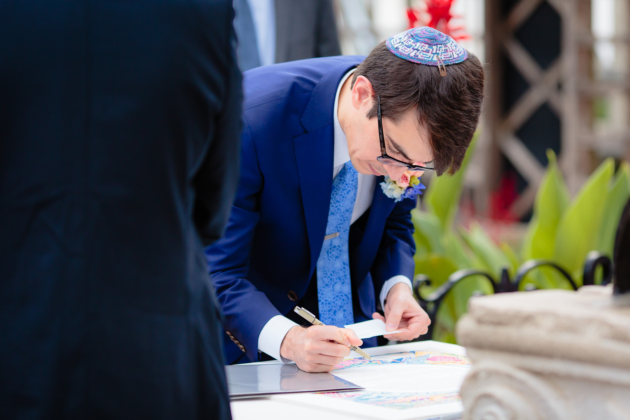 Groom signs the Ketubah at Phipps Conservatory