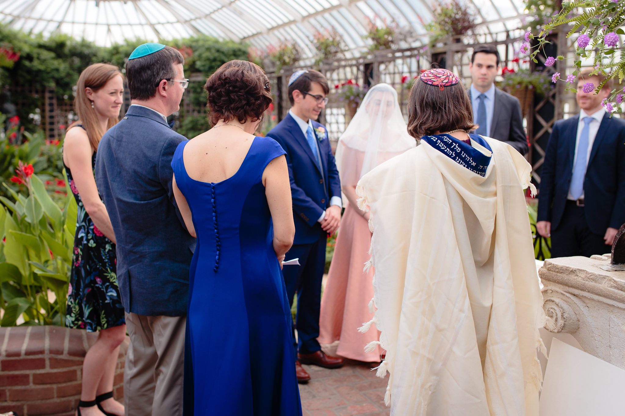 Bride & groom stand with their parents and witnesses after they've signed their Ketubah at Phipps Conservatory