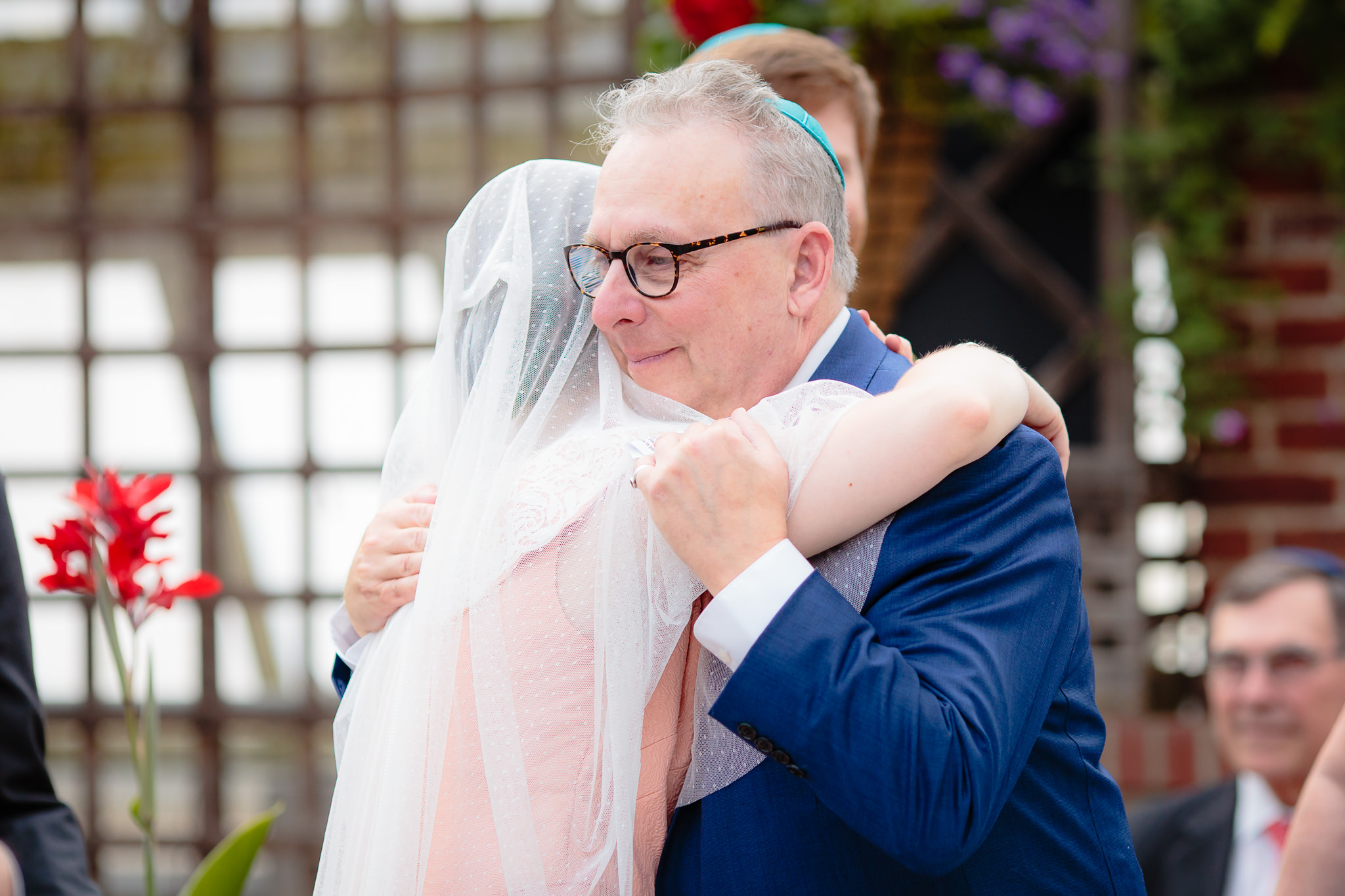 Father of the bride hugs his daughter after the Ketubah signing at Phipps Conservatory