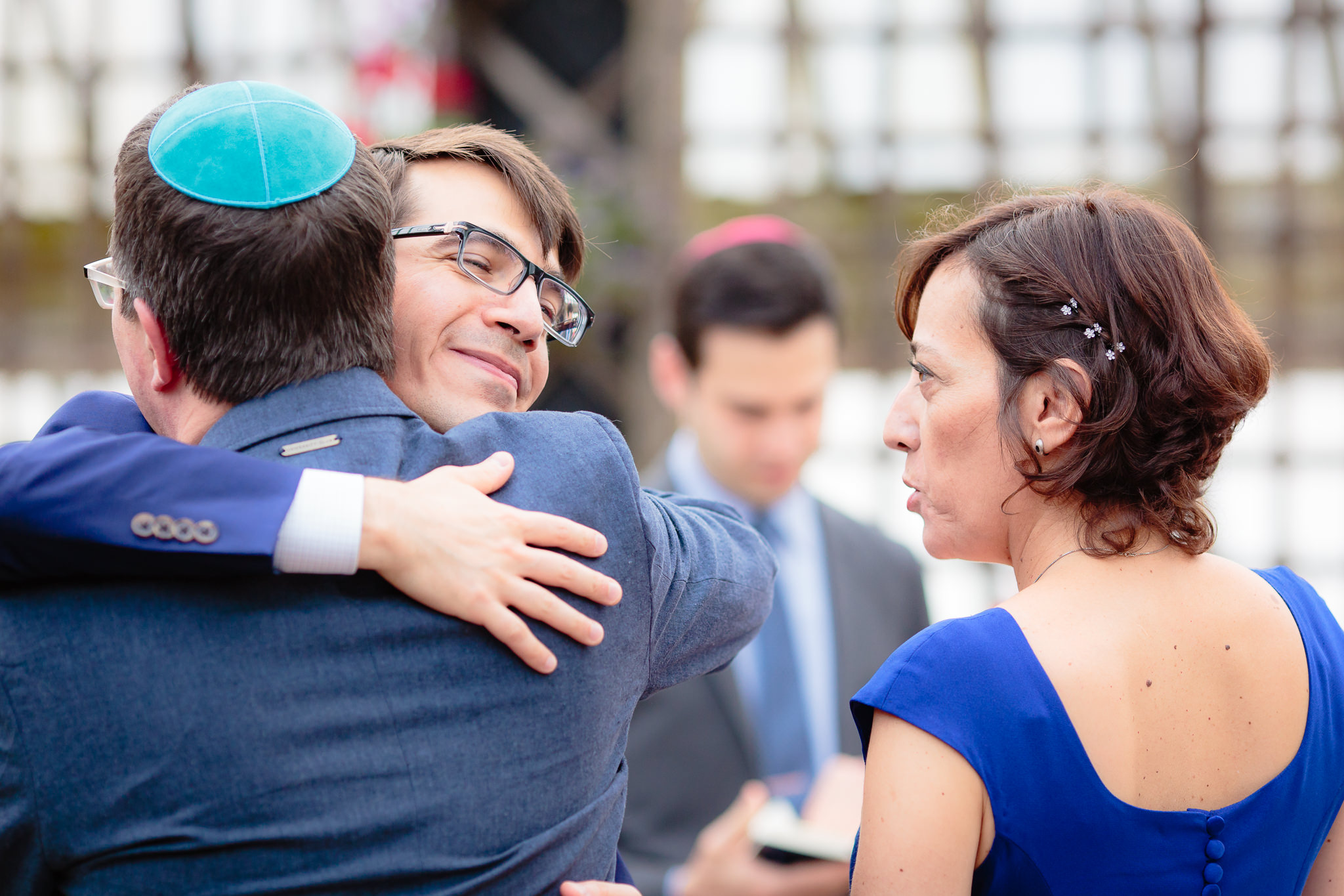 Groom hugs his dad after the Ketubah signing at Phipps Conservatory