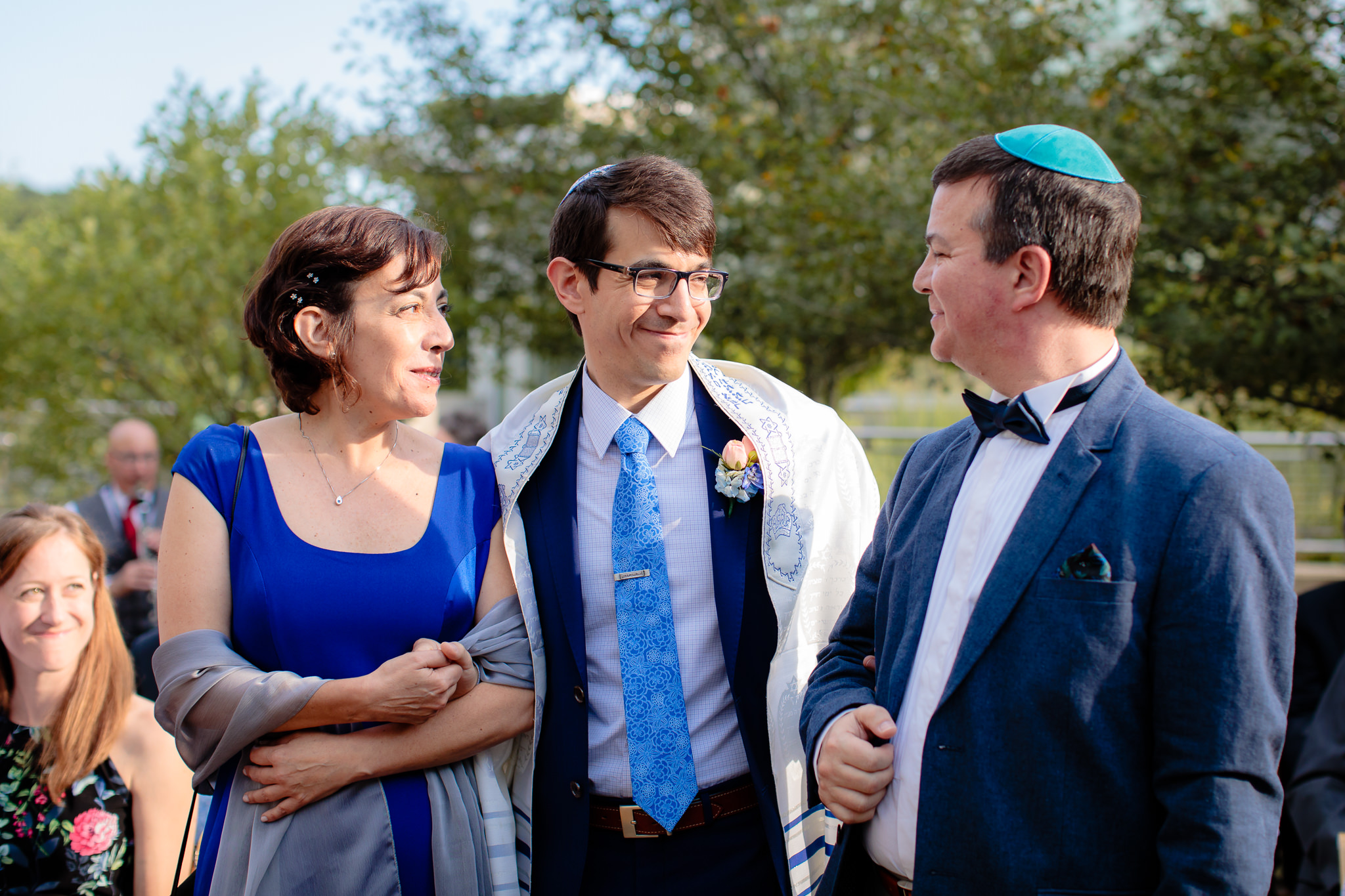 Parents of the groom smile at the groom before a Jewish wedding ceremony at Phipps Conservatory