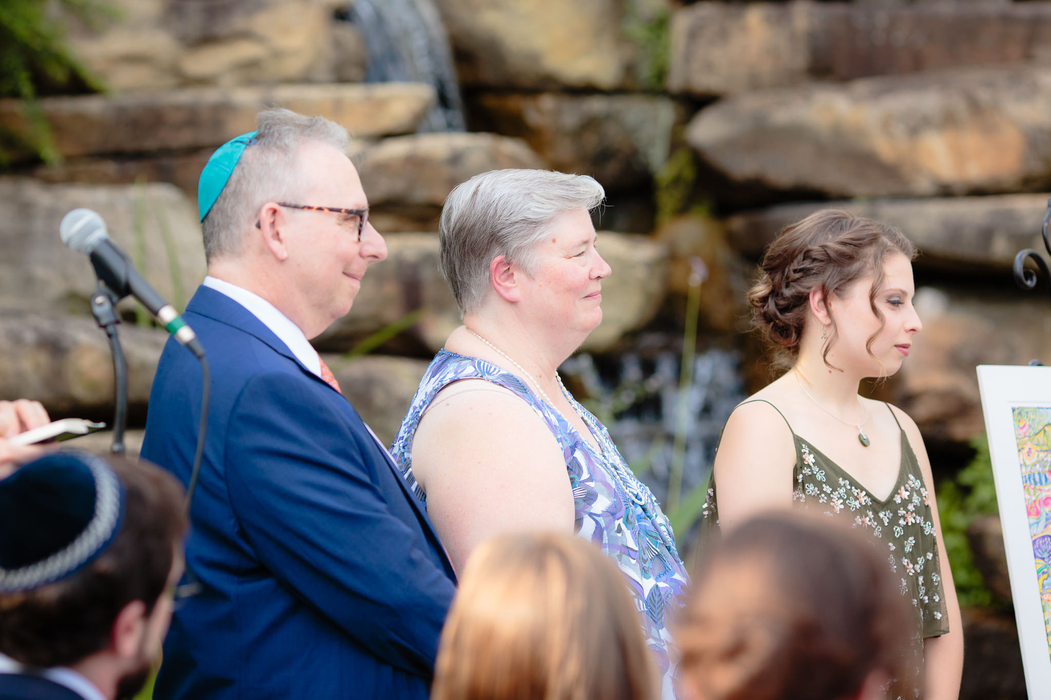 Parents and sister of the bride smile as she gets married at Phipps Conservatory