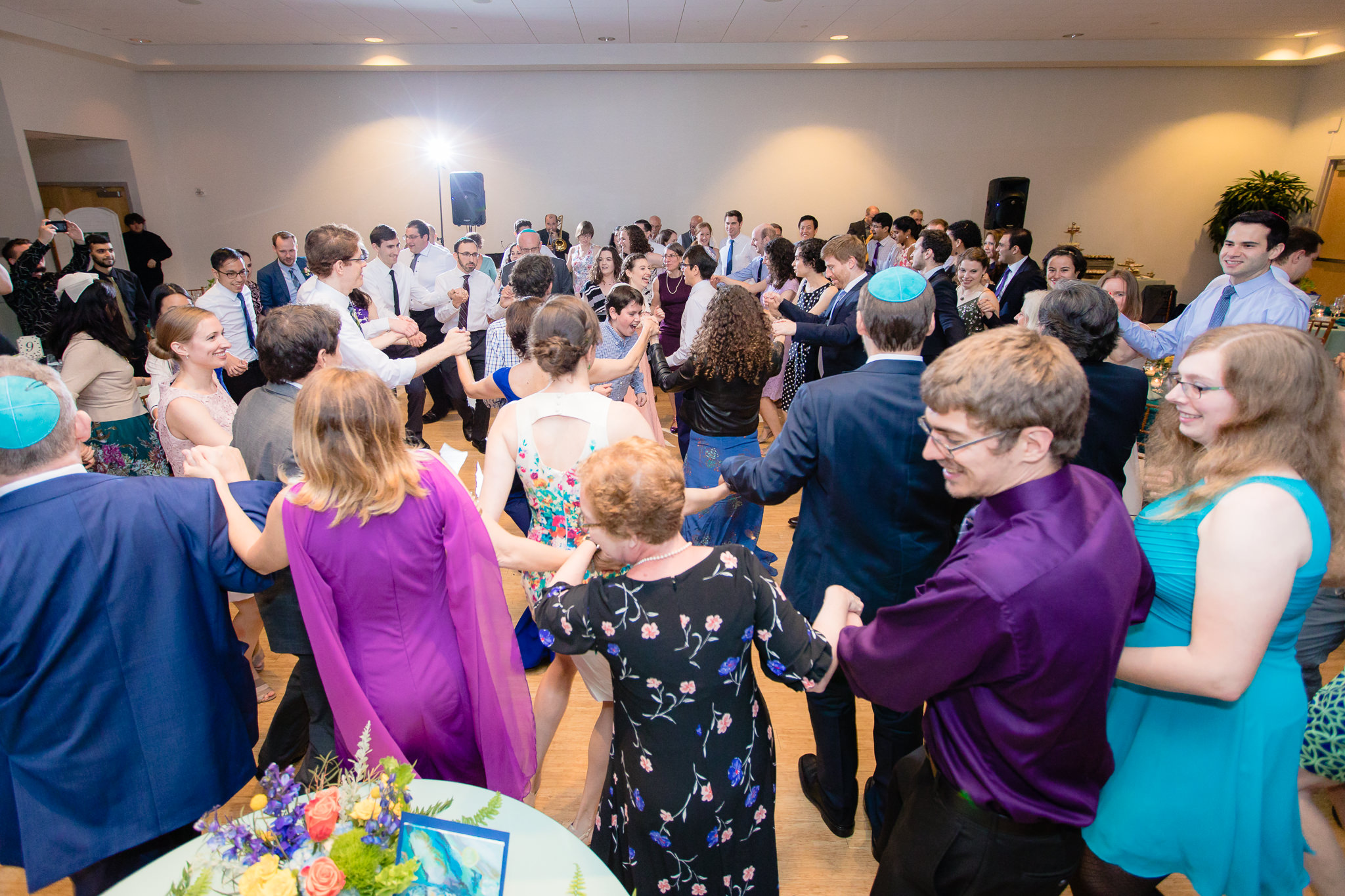 Guests dance the Hora at a Jewish wedding reception at Phipps Conservatory
