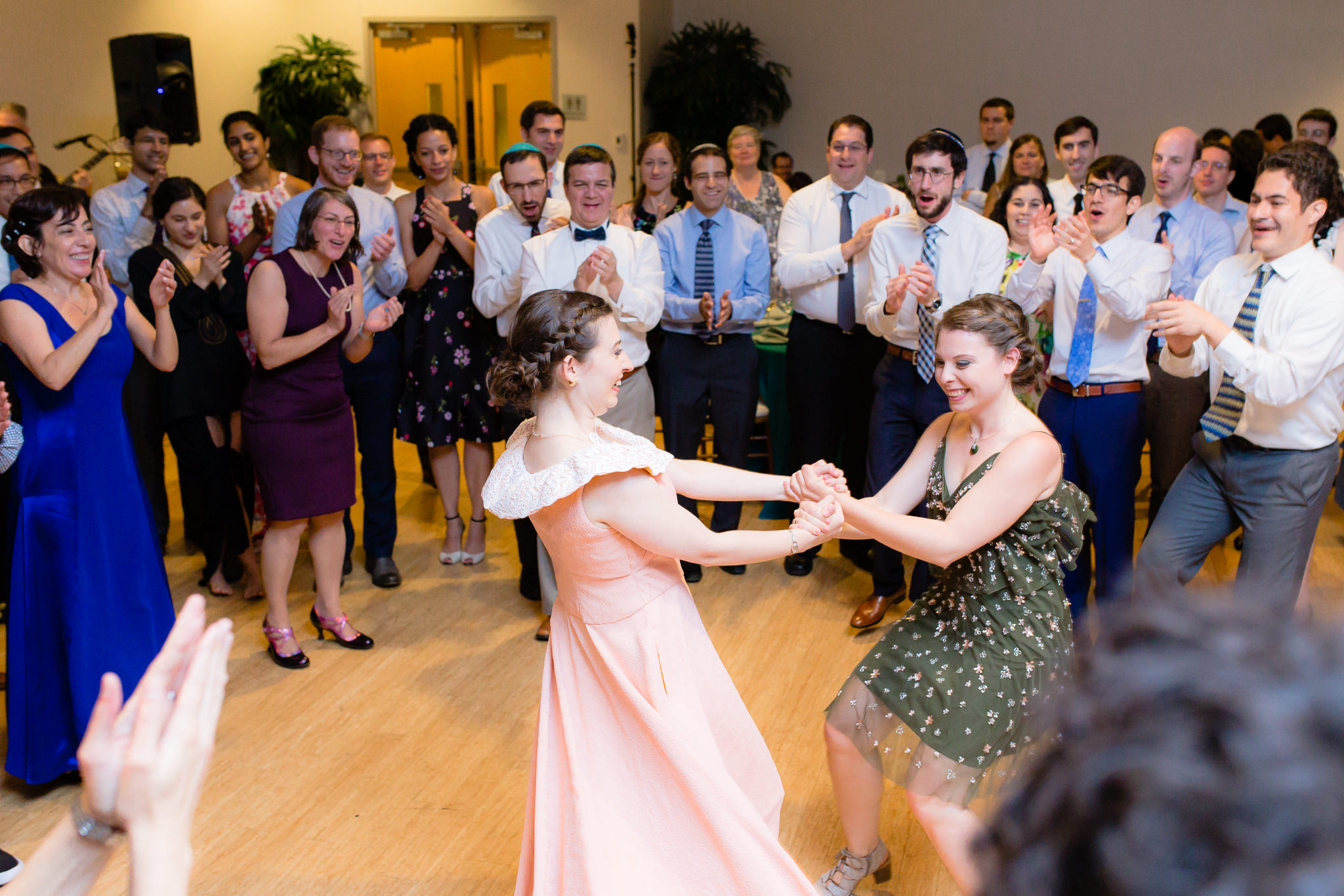 Bride dances with her sister during the hora at a Jewish wedding at Phipps Conservatory