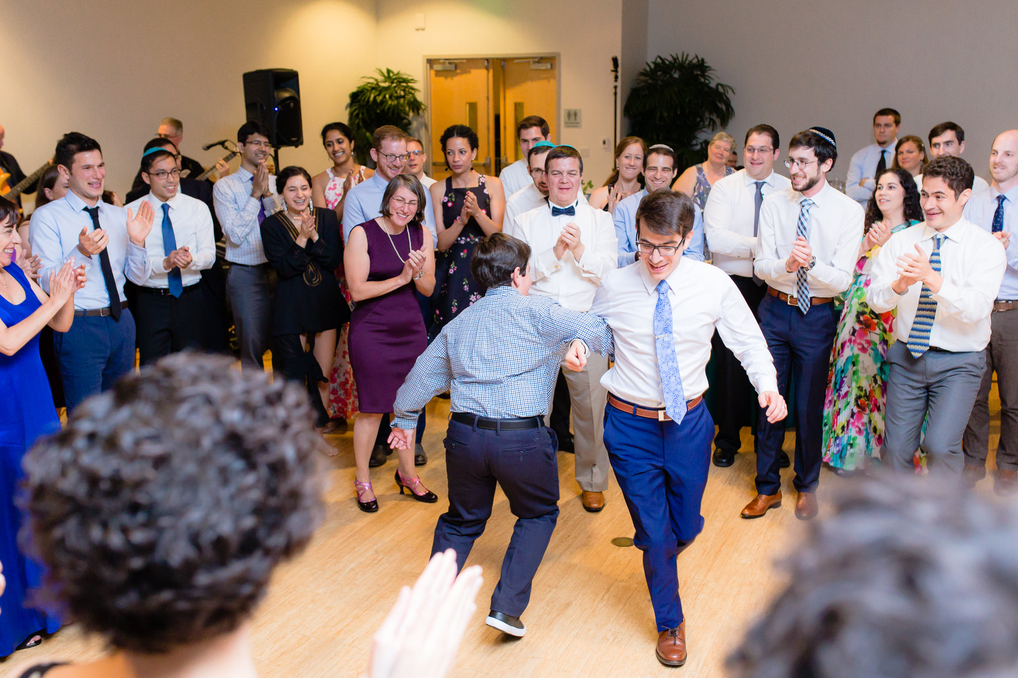 Groom dances with his brother during the hora at a Jewish wedding at Phipps