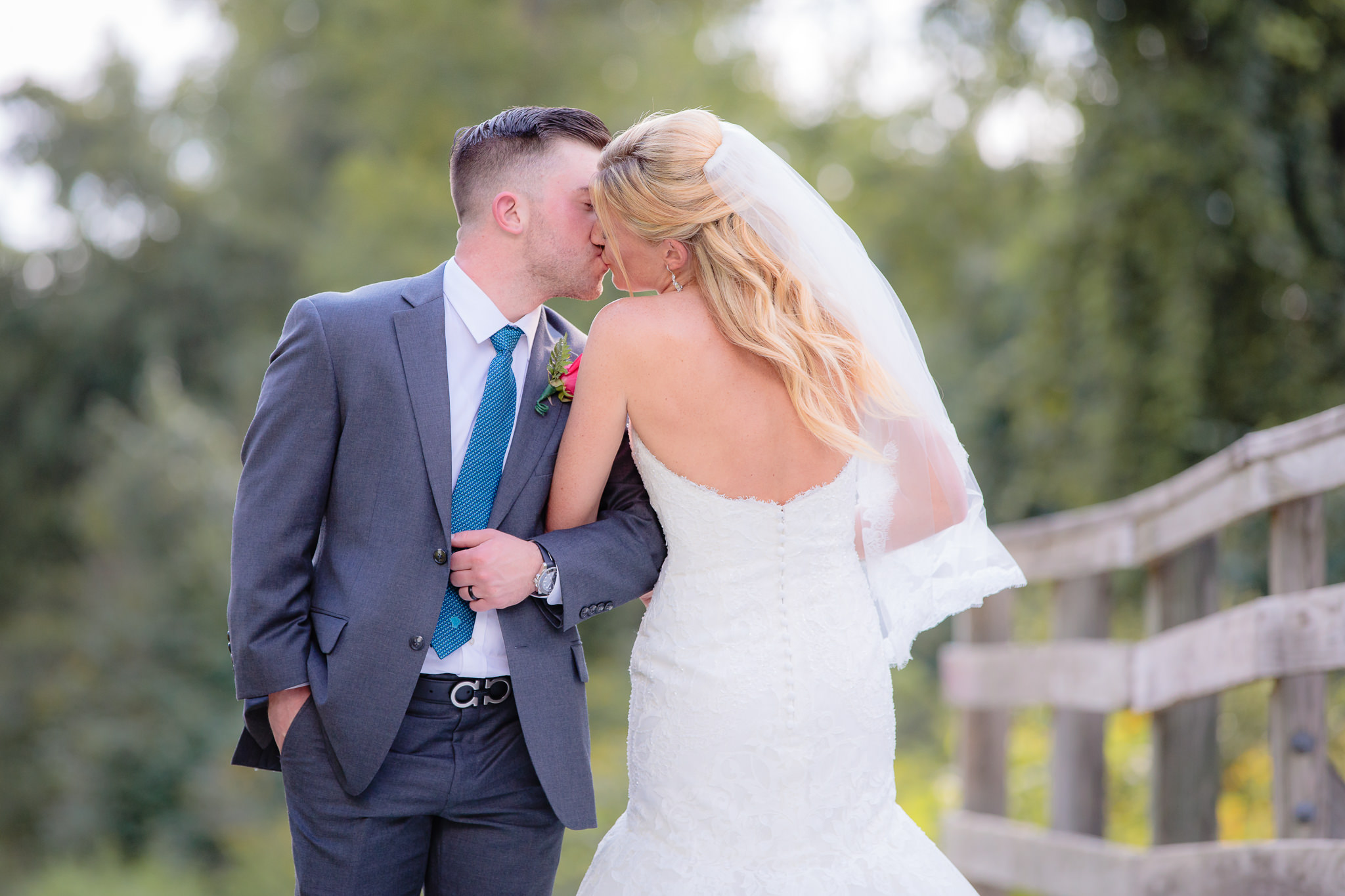 Groom kisses his bride before their Pittsburgh Airport Marriott wedding