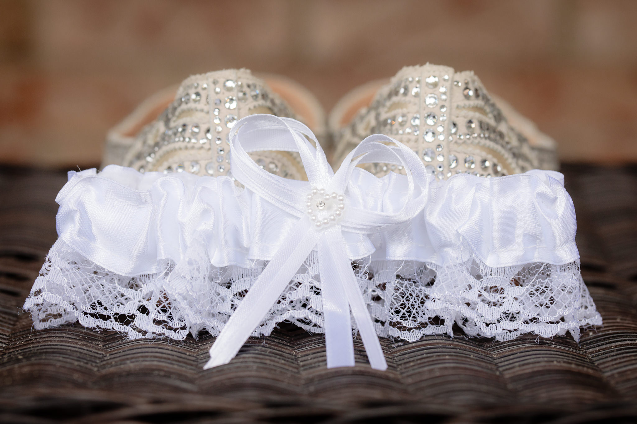White garter leans against bride's shoes for a Greystone Fields wedding