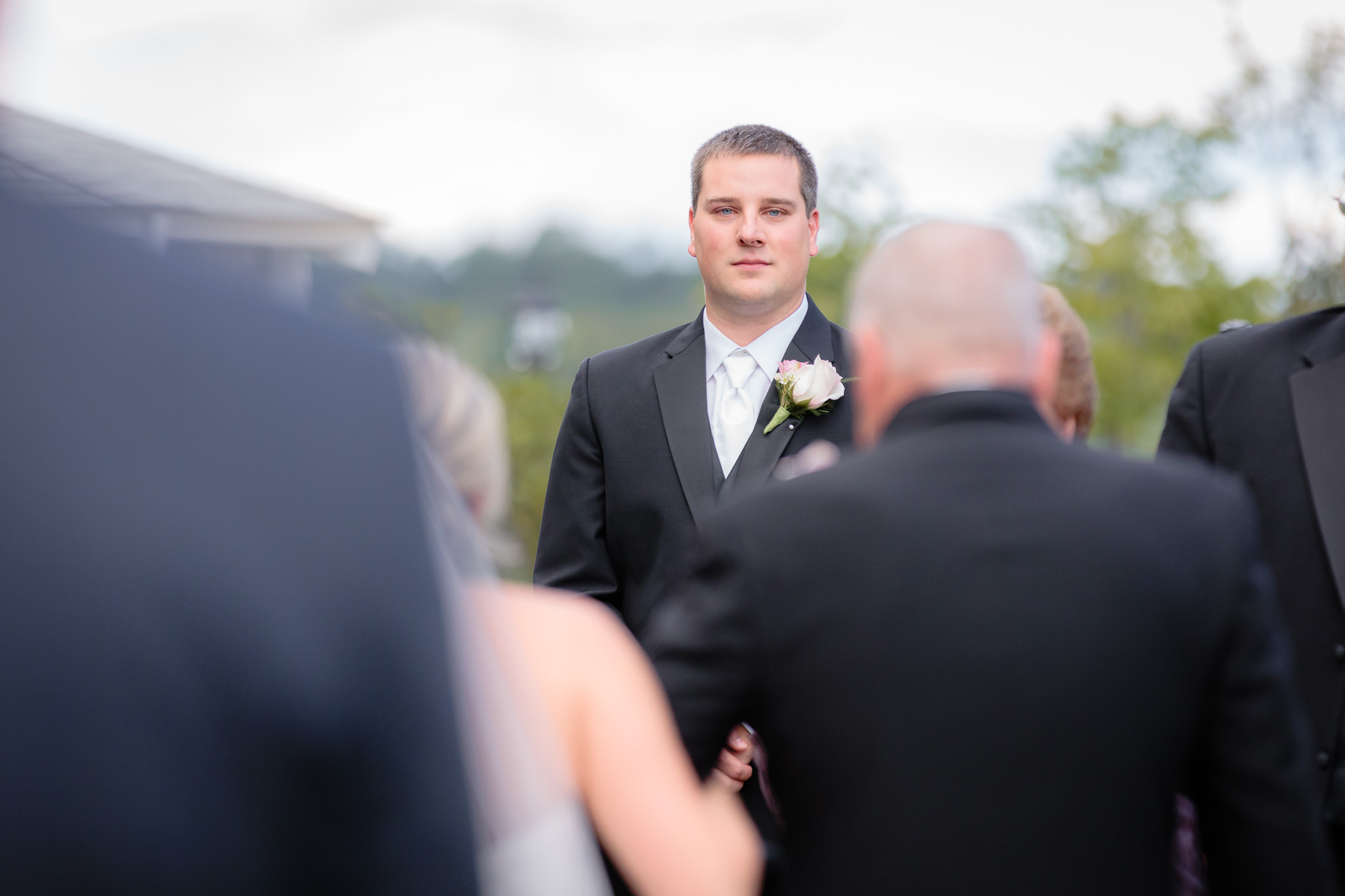 Groom sees his bride coming down the aisle at Greystone Fields