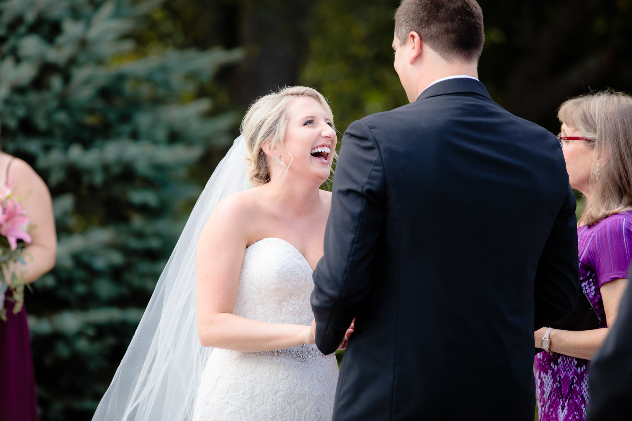 Bride laughs during the ceremony at Greystone Fields