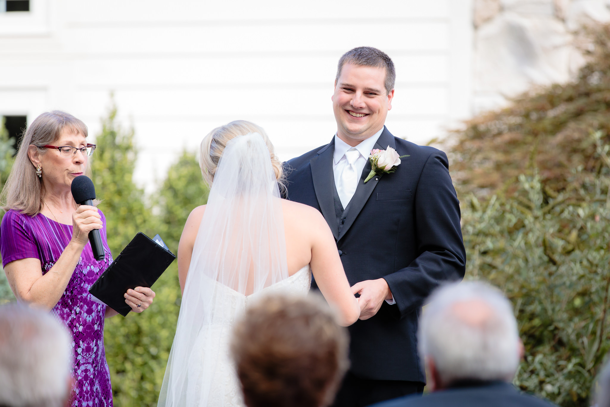Groom laughs during the ceremony at Greystone Fields