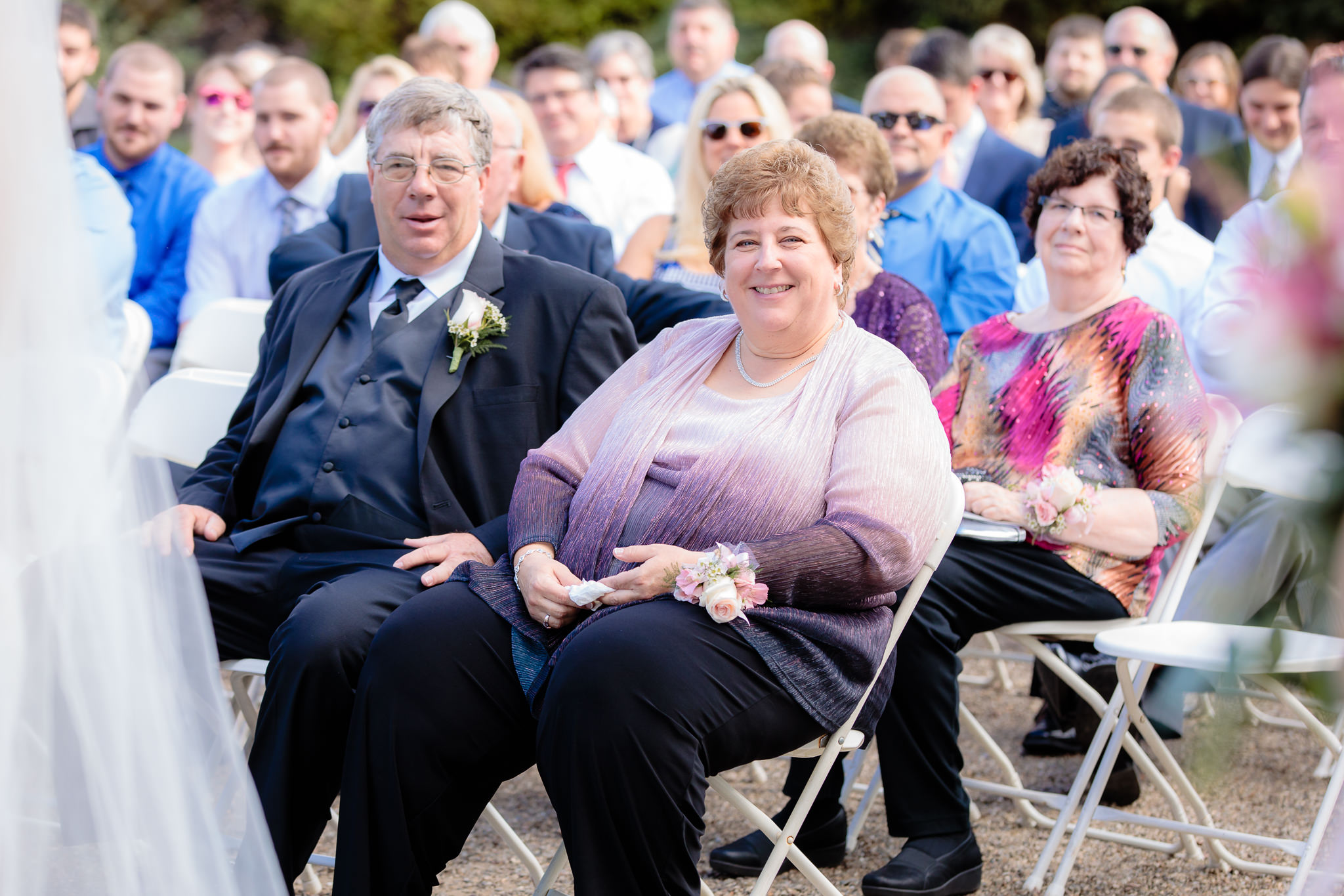 Parents of the groom smile during a Greystone Fields wedding ceremony