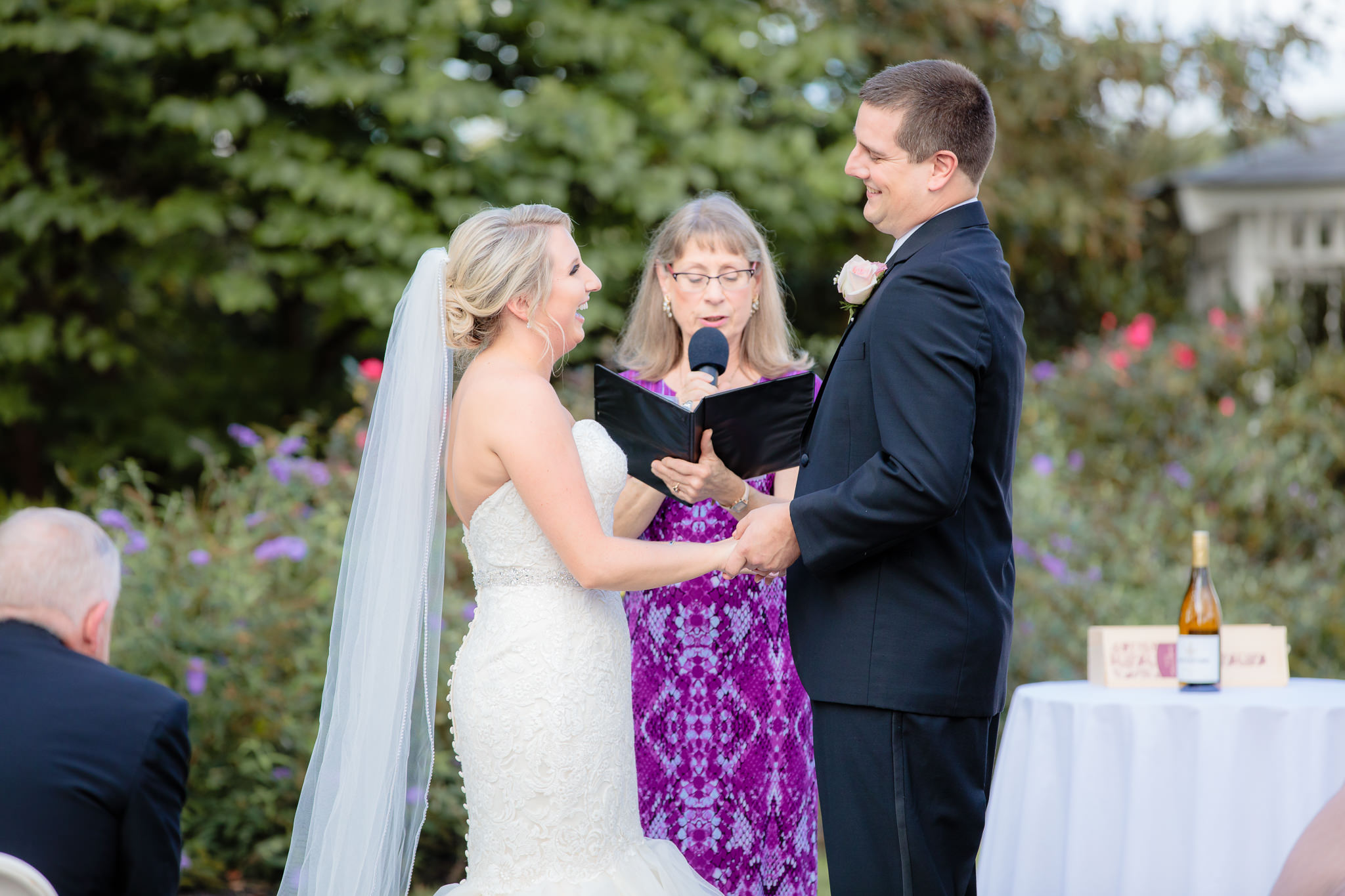 Bride & groom laugh together during their Greystone Fields wedding ceremony