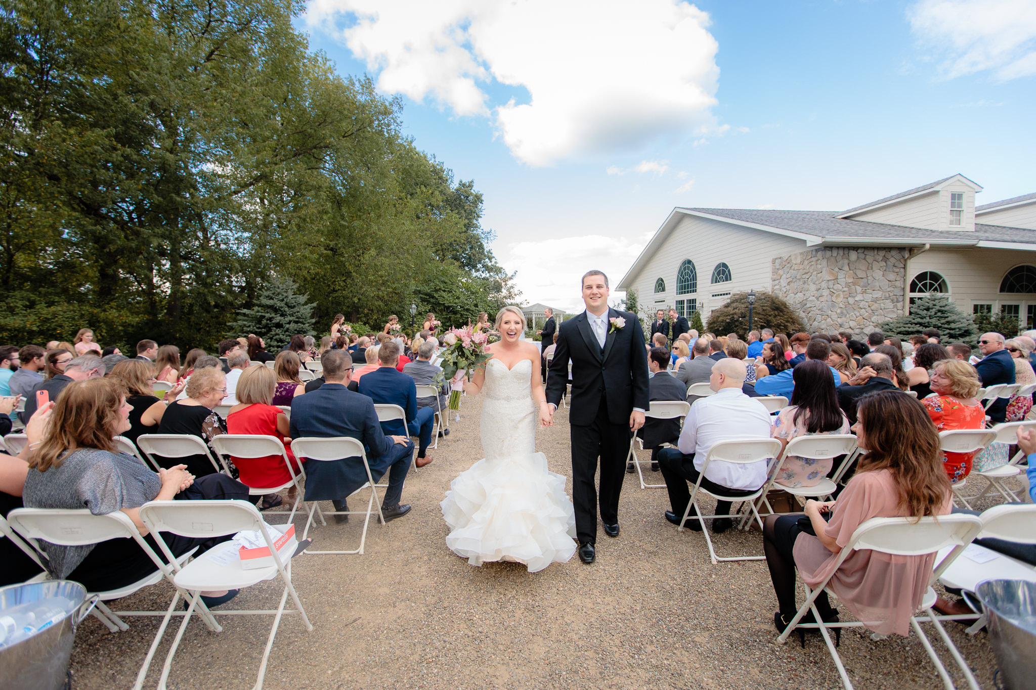 Newlyweds exit their wedding ceremony at Greystone Fields