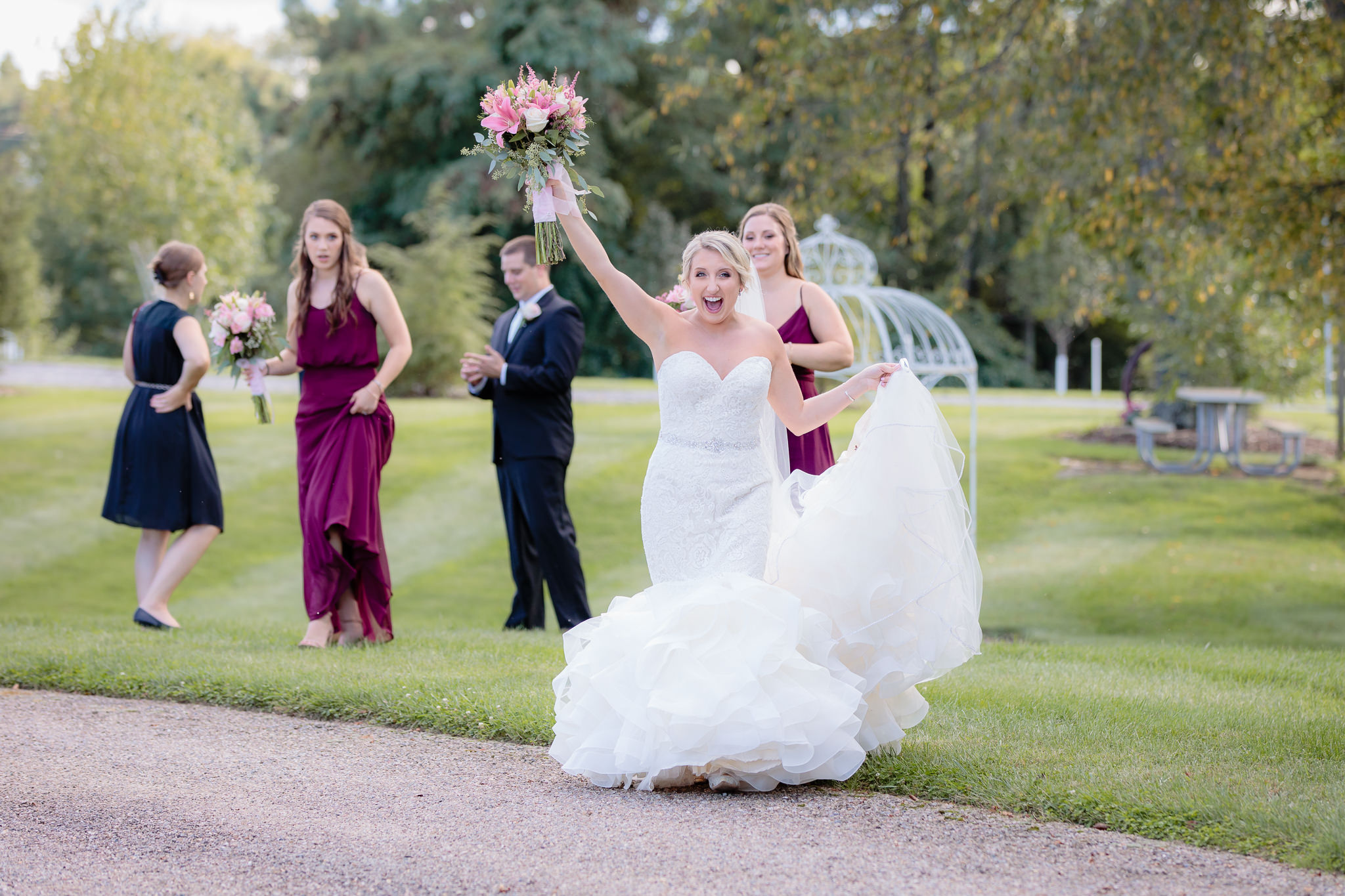 Bride cheers during portraits at Greystone Fields