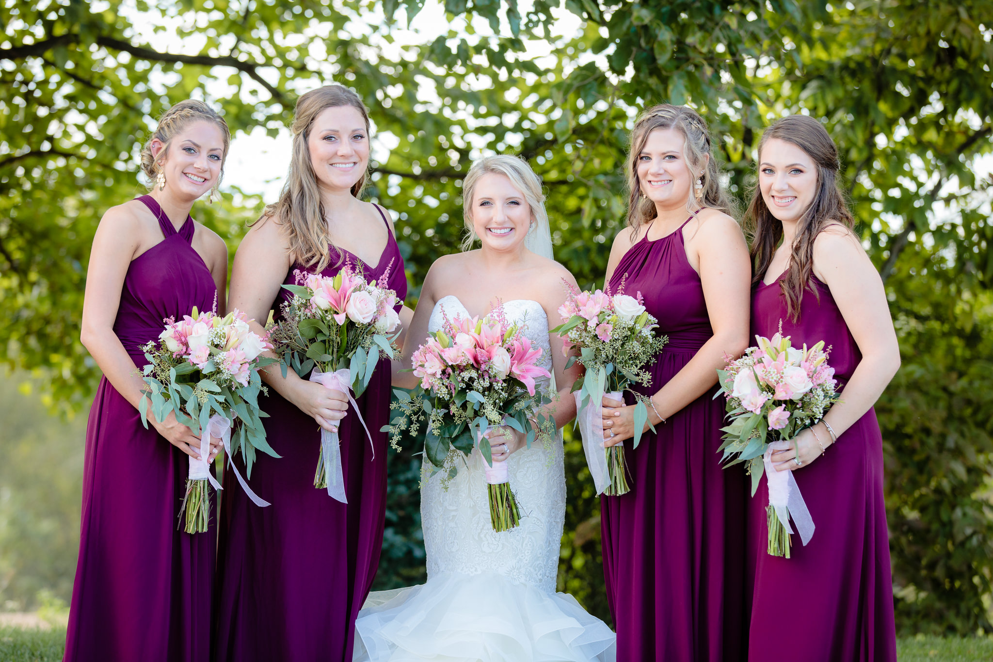 Bride & bridesmaids wearing burgundy Bill Levkoff dresses at Greystone Fields