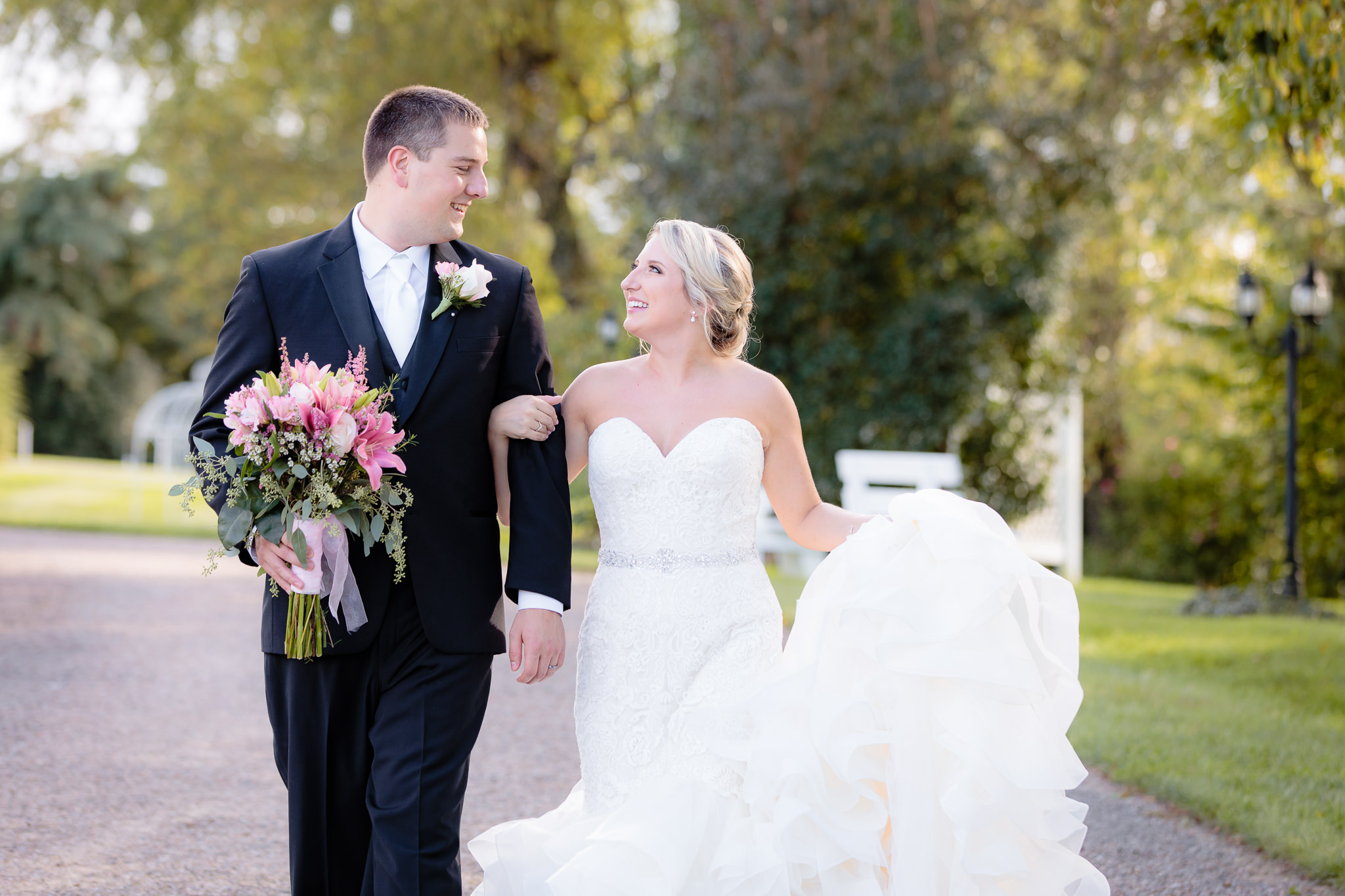 Bride & groom walk together during portraits at Greystone Fields