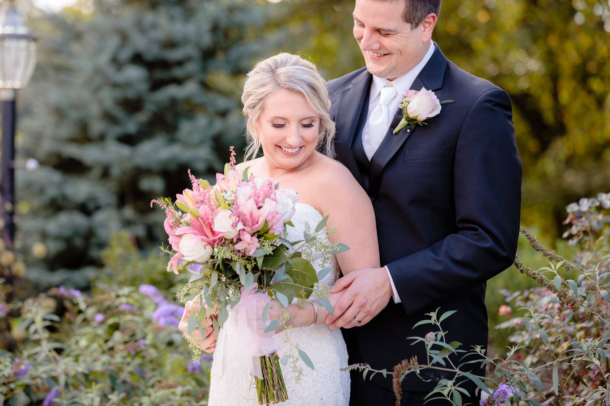 Groom smiles as his bride laughs at Greystone Fields