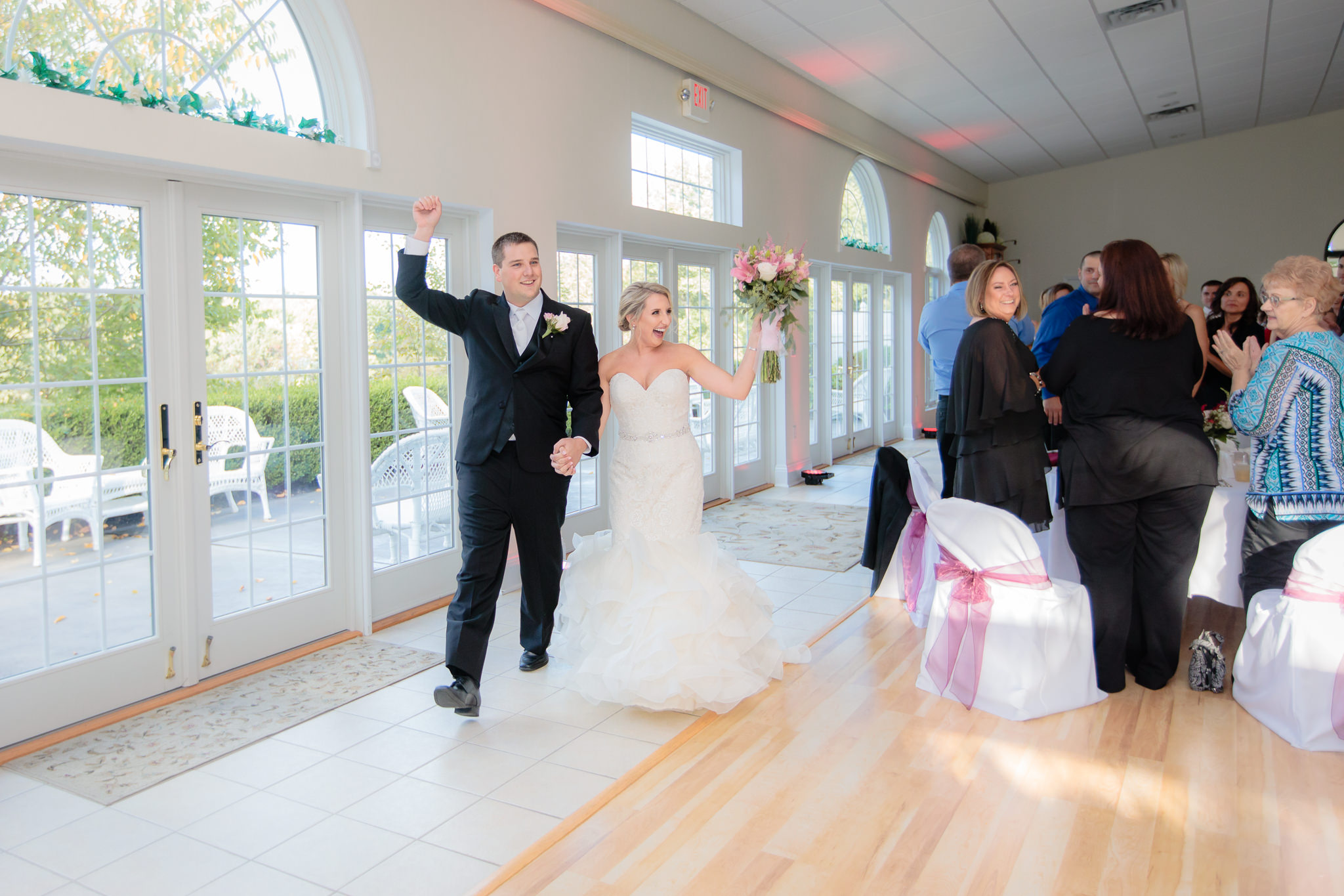 Newlyweds enter their wedding reception at Greystone Fields