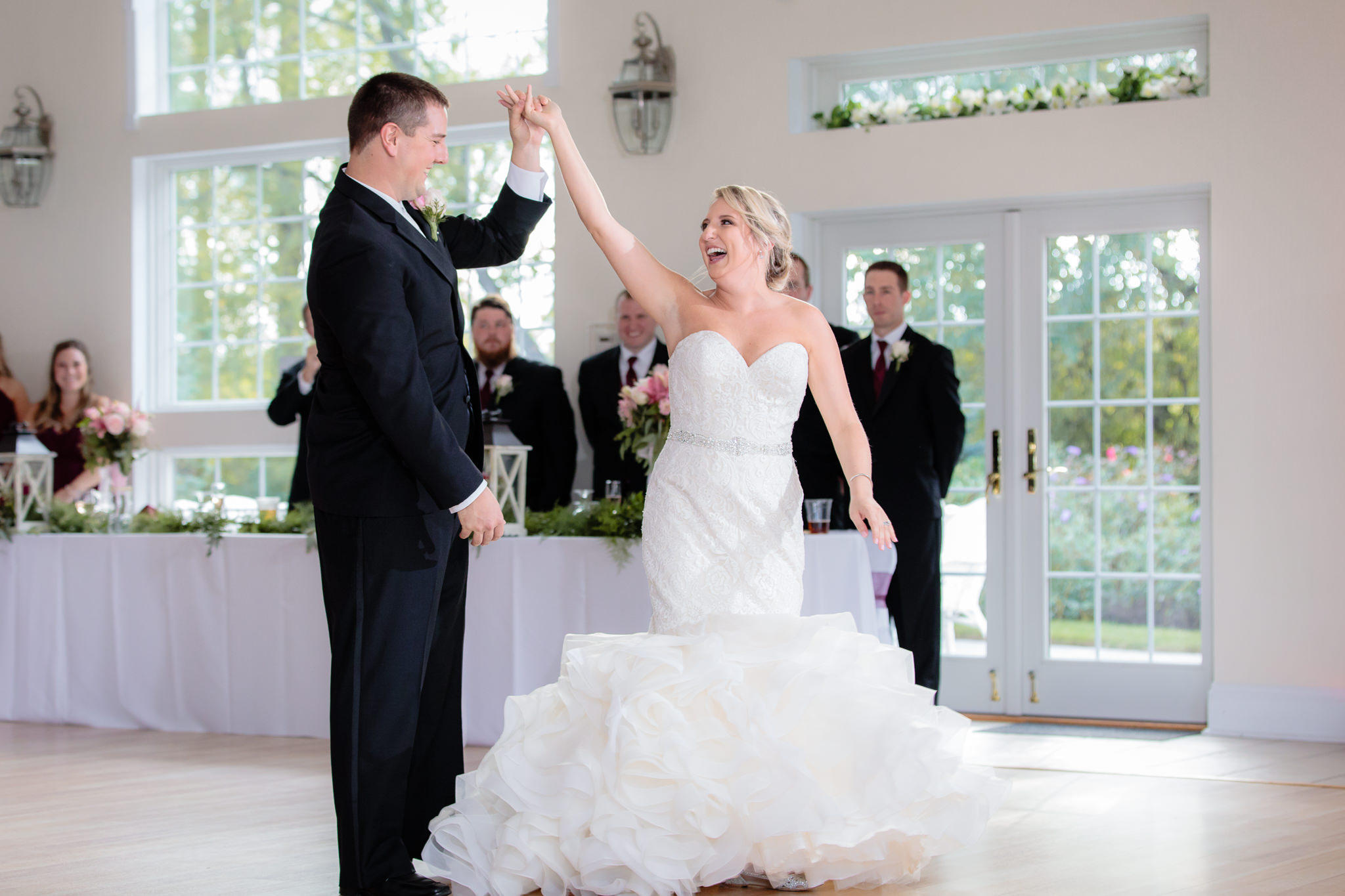 Groom twirls his bride during their first dance at Greystone Fields